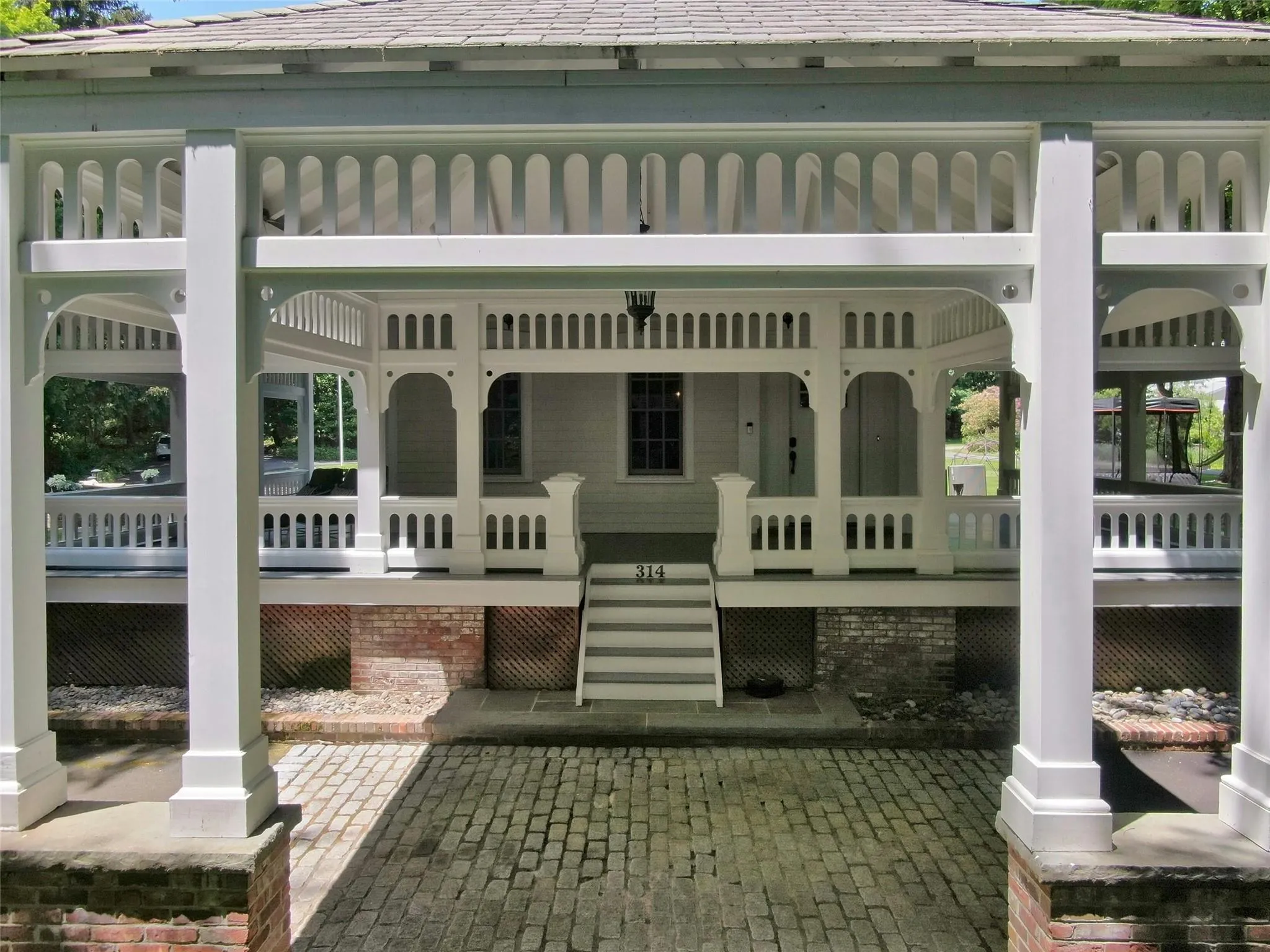 Rear view of property with covered porch Rear view of property with covered porch