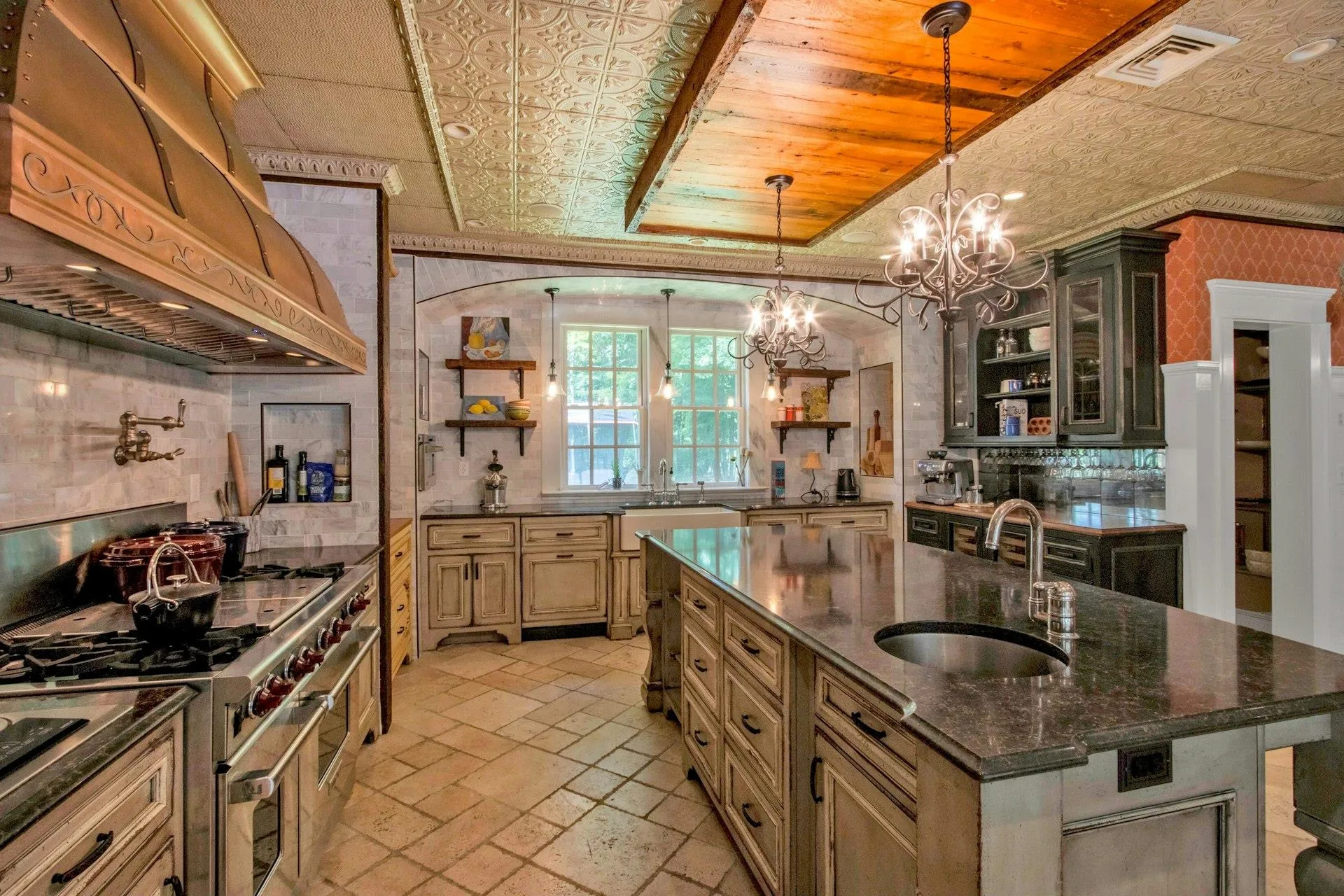 Kitchen with open shelves, a sink, premium range hood, double oven range, and a chandelier Kitchen with open shelves, a sink, premium range hood, double oven range, and a chandelier