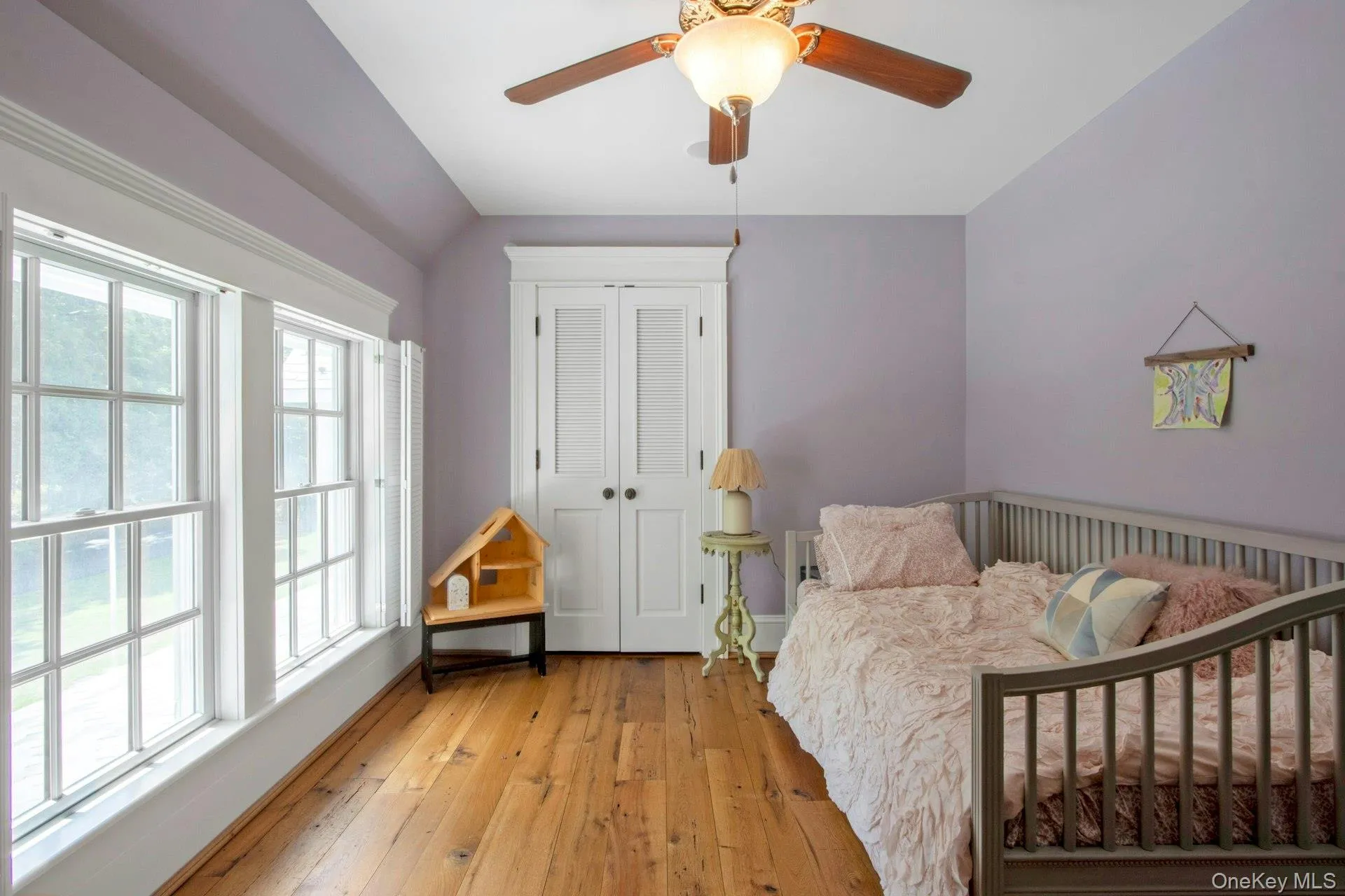 Bedroom featuring light wood-type flooring, a closet, a ceiling fan, and baseboards Bedroom featuring light wood-type flooring, a closet, a ceiling fan, and baseboards