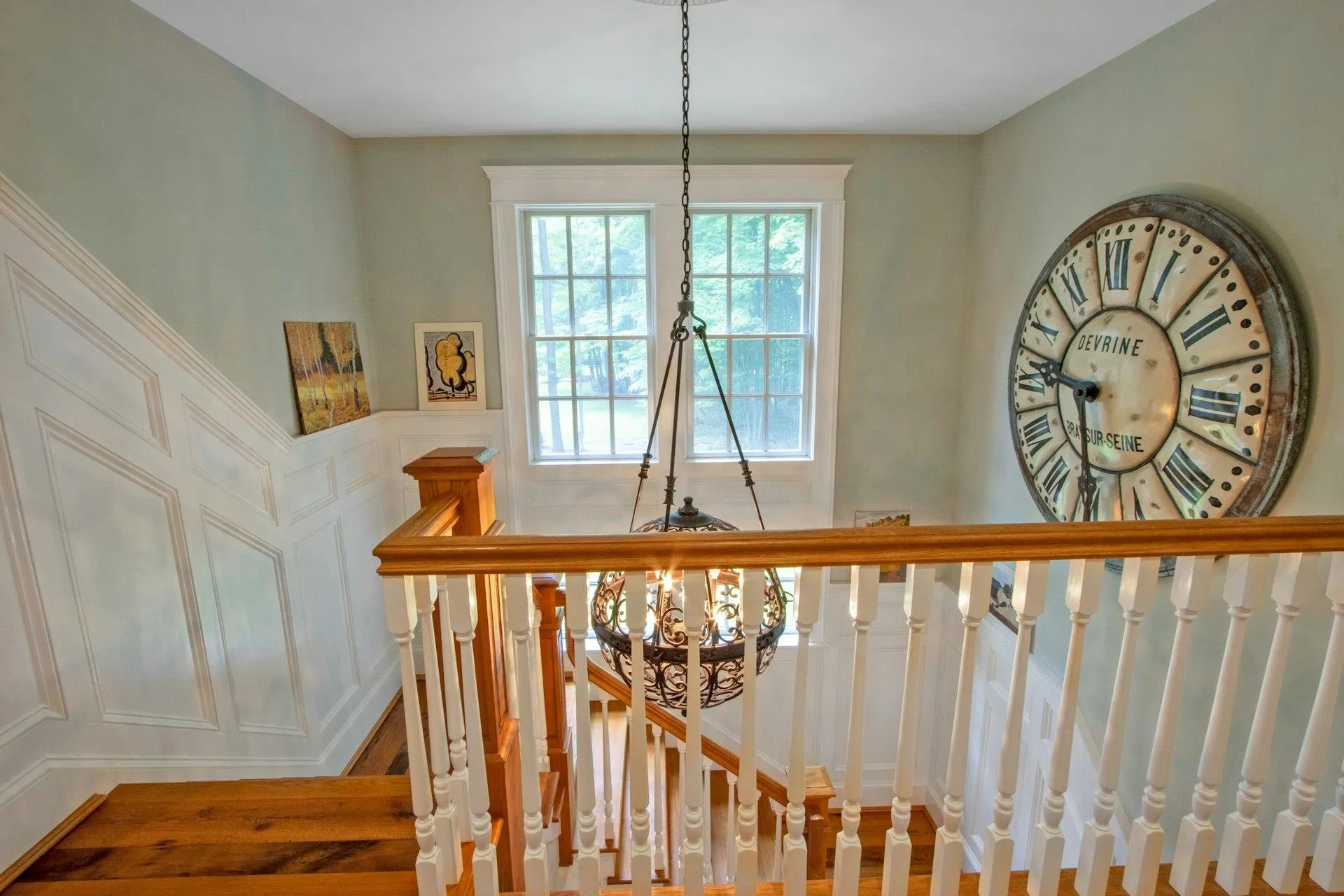 Stairs featuring a chandelier and a decorative wall Stairs featuring a chandelier and a decorative wall