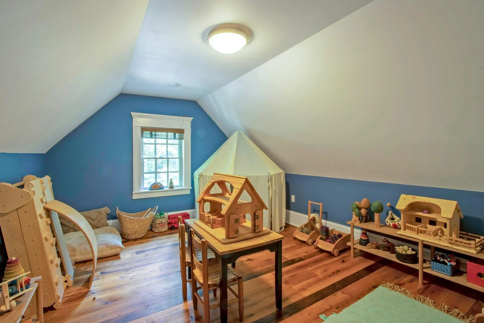 Rec room featuring wood finished floors and vaulted ceiling Rec room featuring wood finished floors and vaulted ceiling