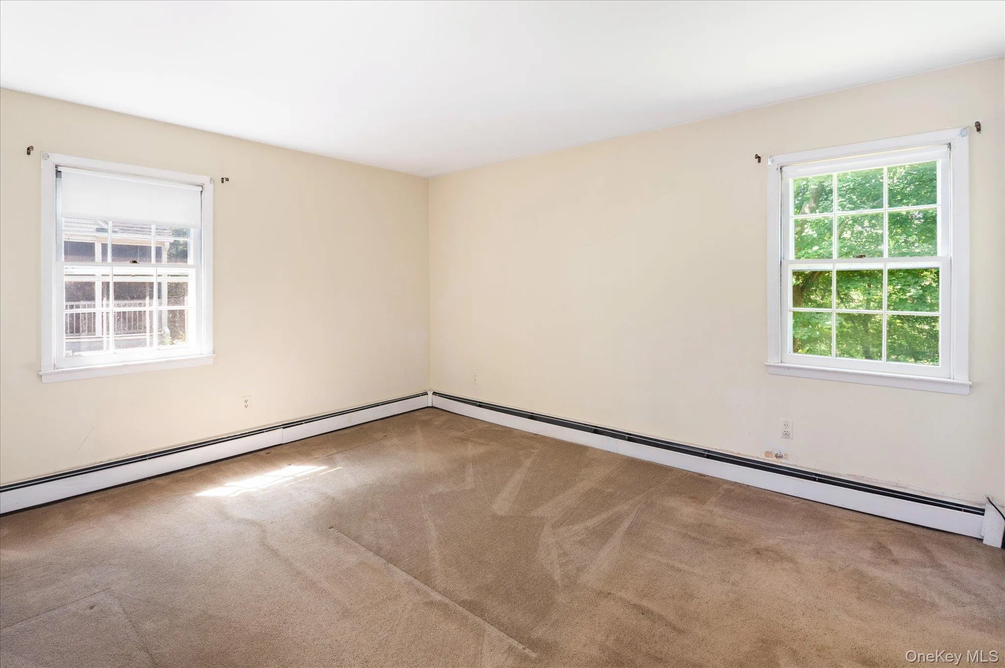 Alternative View of Primary Bedroom - Wood floors underneath carpet. Alternative View of Primary Bedroom - Wood floors underneath carpet.