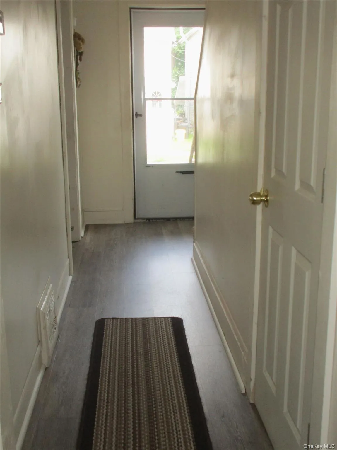 Hallway facing from kitchen vinyl flooring to front entrance Hallway facing from kitchen vinyl flooring to front entrance