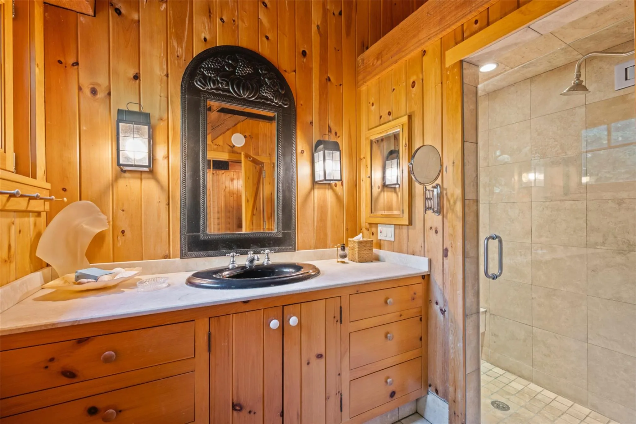 Bathroom featuring a shower stall, vanity, and wood walls Bathroom featuring a shower stall, vanity, and wood walls