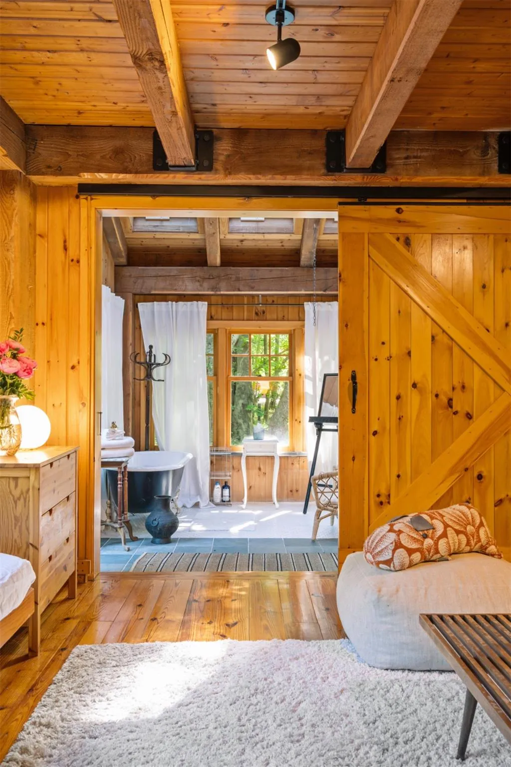 Living room with wood-type flooring, wooden walls, and wooden ceiling with exposed beams Living room with wood-type flooring, wooden walls, and wooden ceiling with exposed beams