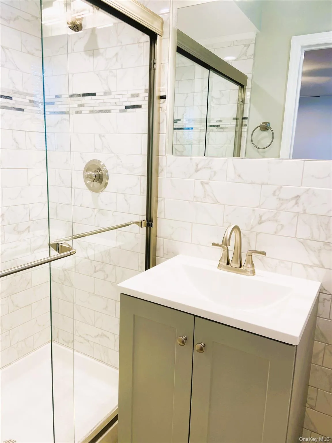 Full bath with a shower stall, tile walls, and vanity Full bath with a shower stall, tile walls, and vanity