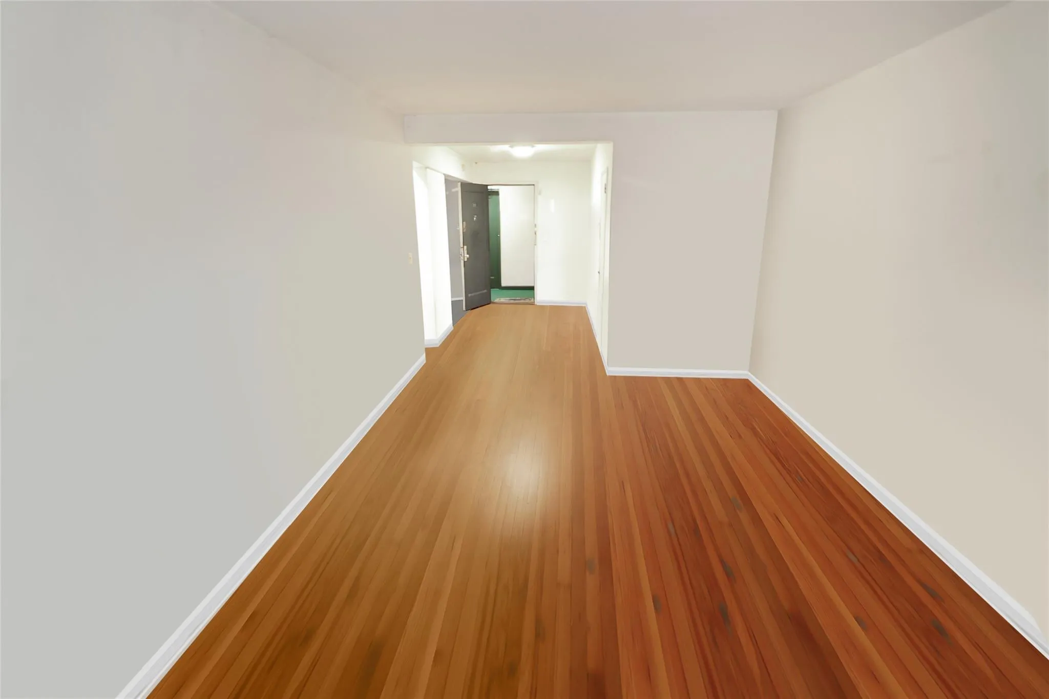 Empty room with baseboards and wood finished floors Empty room with baseboards and wood finished floors