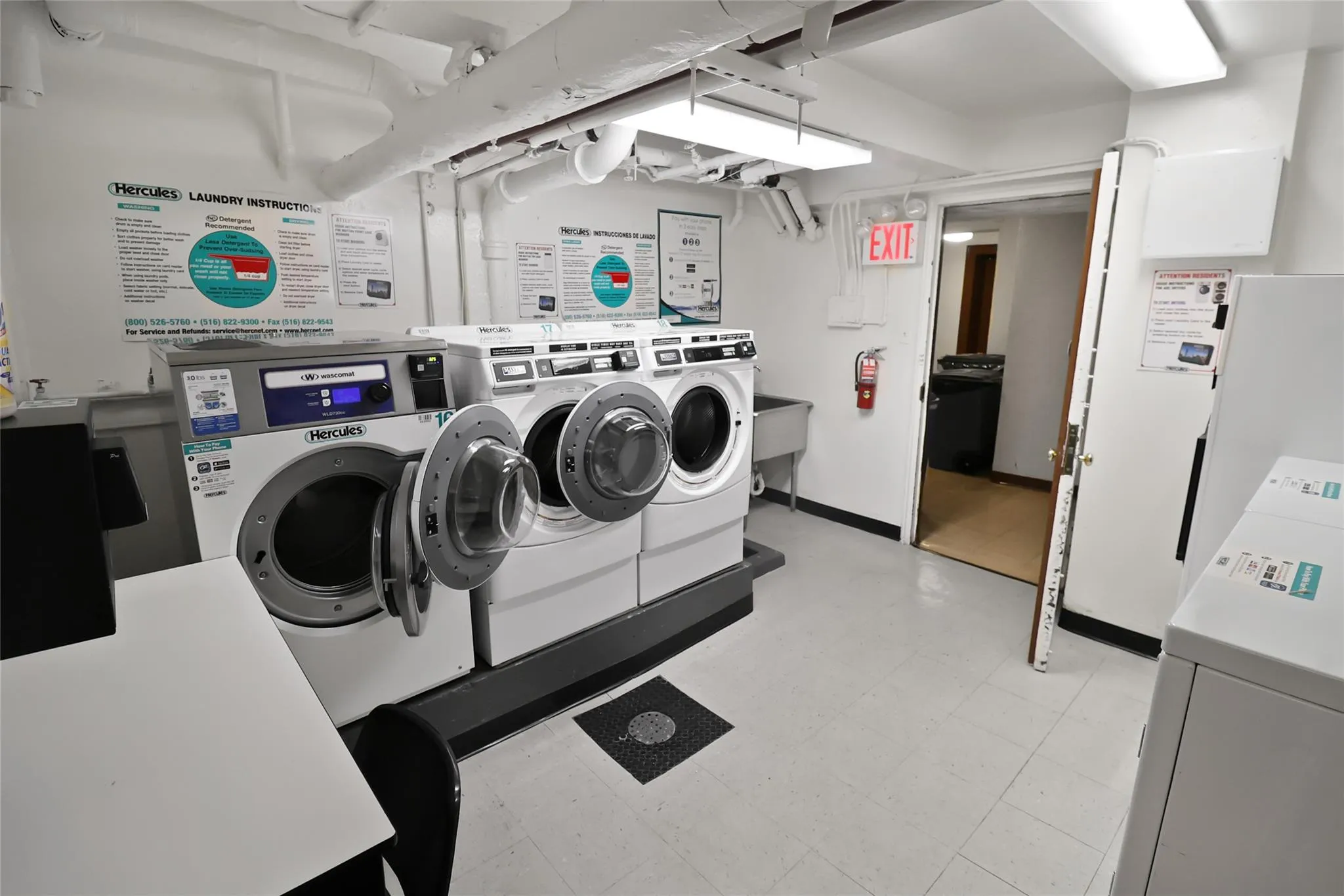 Communal laundry room featuring separate washer and dryer and light flooring Communal laundry room featuring separate washer and dryer and light flooring