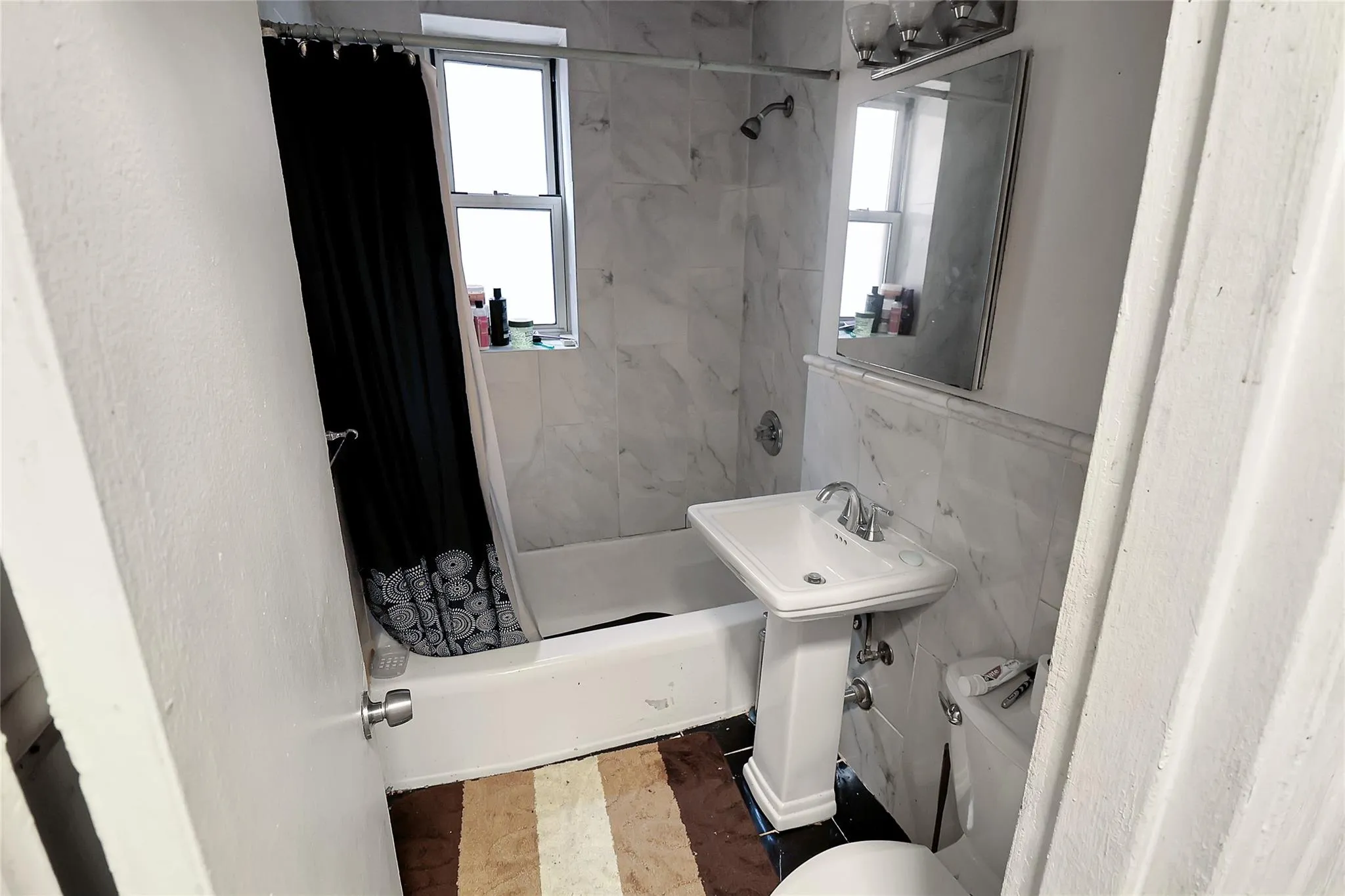 Bathroom with toilet and tile walls Bathroom with toilet and tile walls