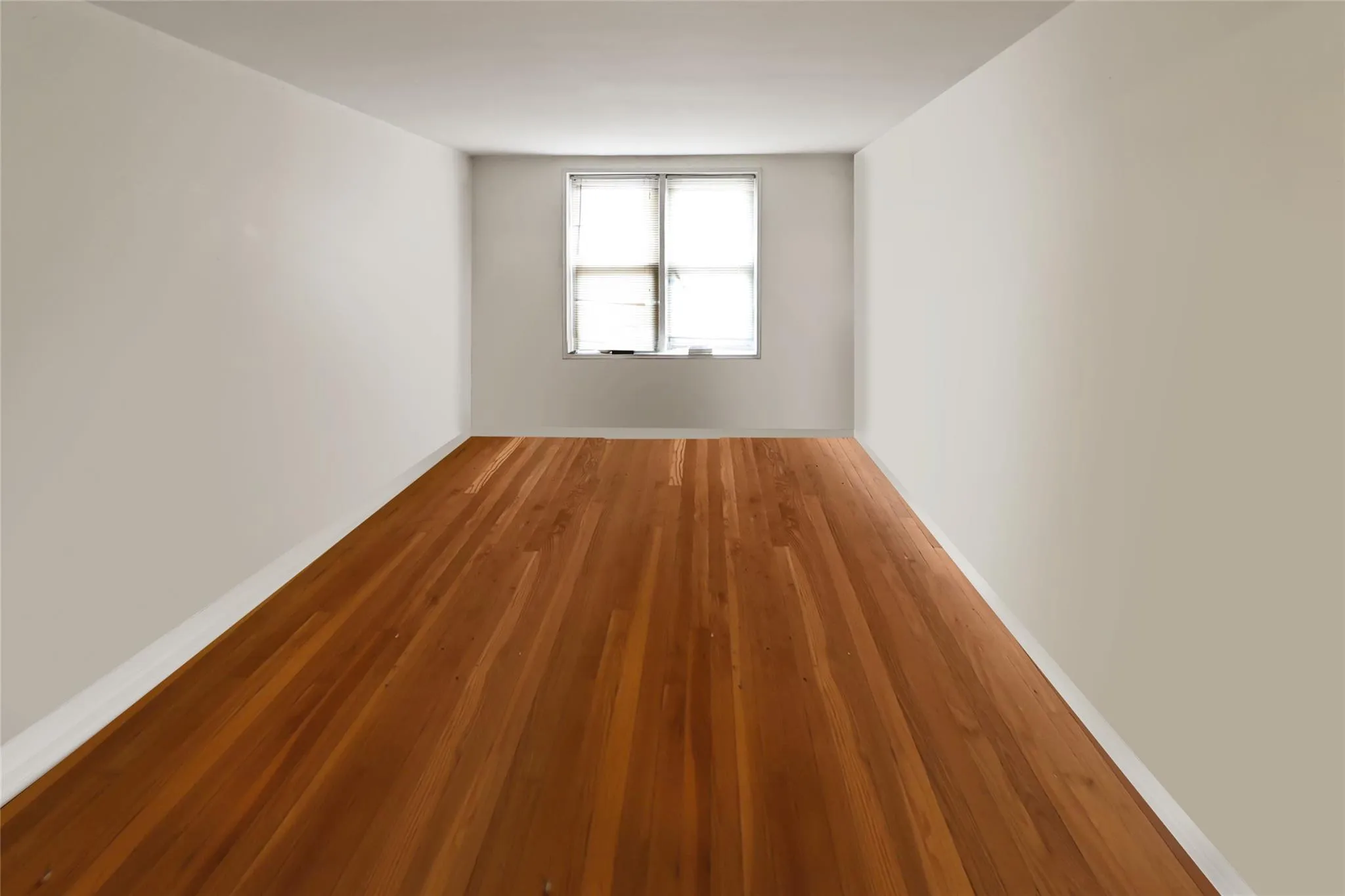 Empty room featuring wood finished floors and baseboards Empty room featuring wood finished floors and baseboards