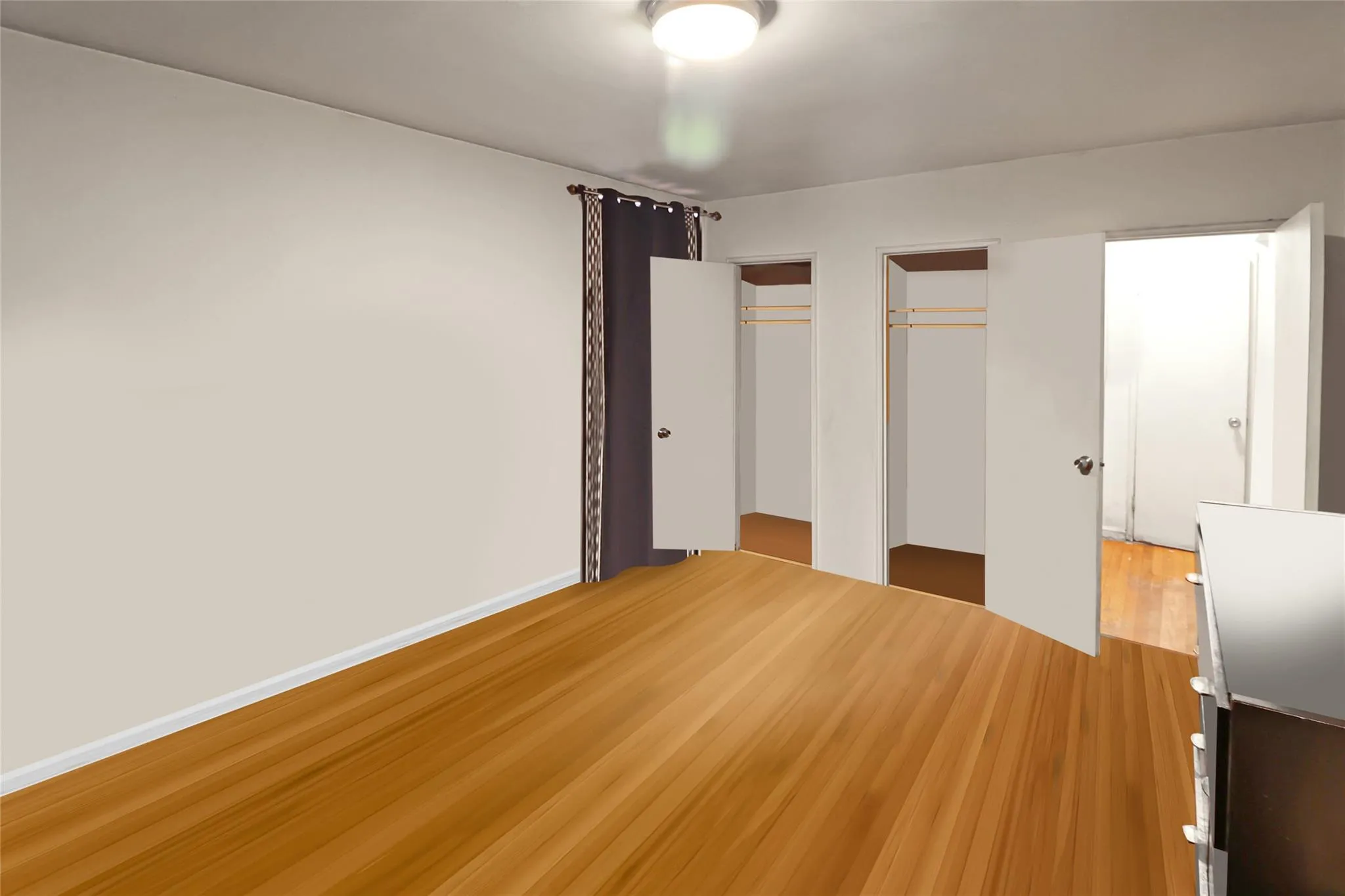 Unfurnished bedroom featuring multiple closets and wood finished floors Unfurnished bedroom featuring multiple closets and wood finished floors