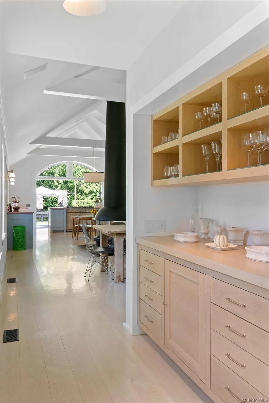 Bar featuring vaulted ceiling and a wood stove Bar featuring vaulted ceiling and a wood stove