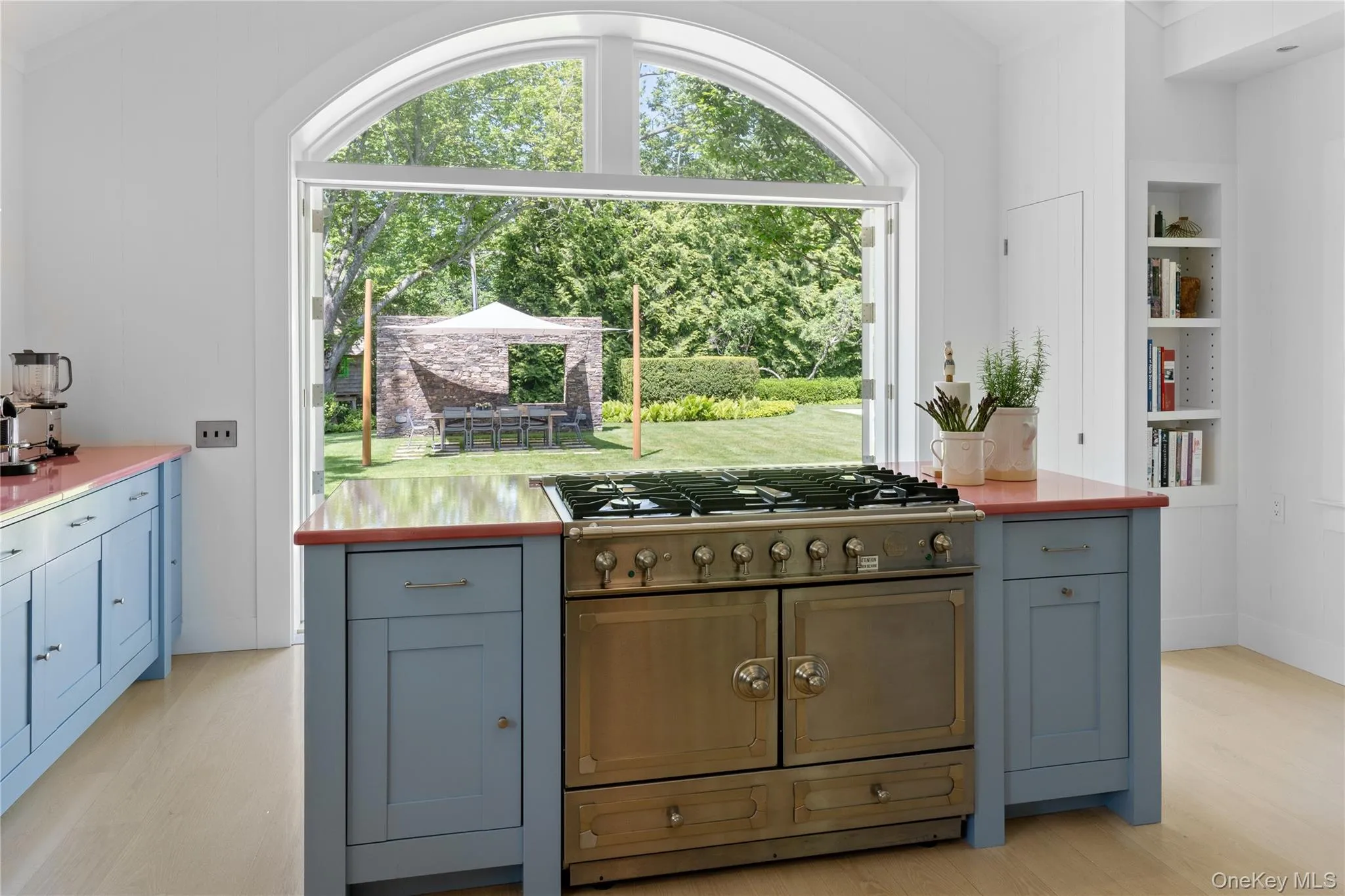 Kitchen with light wood-style flooring, plenty of natural light, built in shelves, light countertops, and crown molding Kitchen with light wood-style flooring, plenty of natural light, built in shelves, light countertops, and crown molding