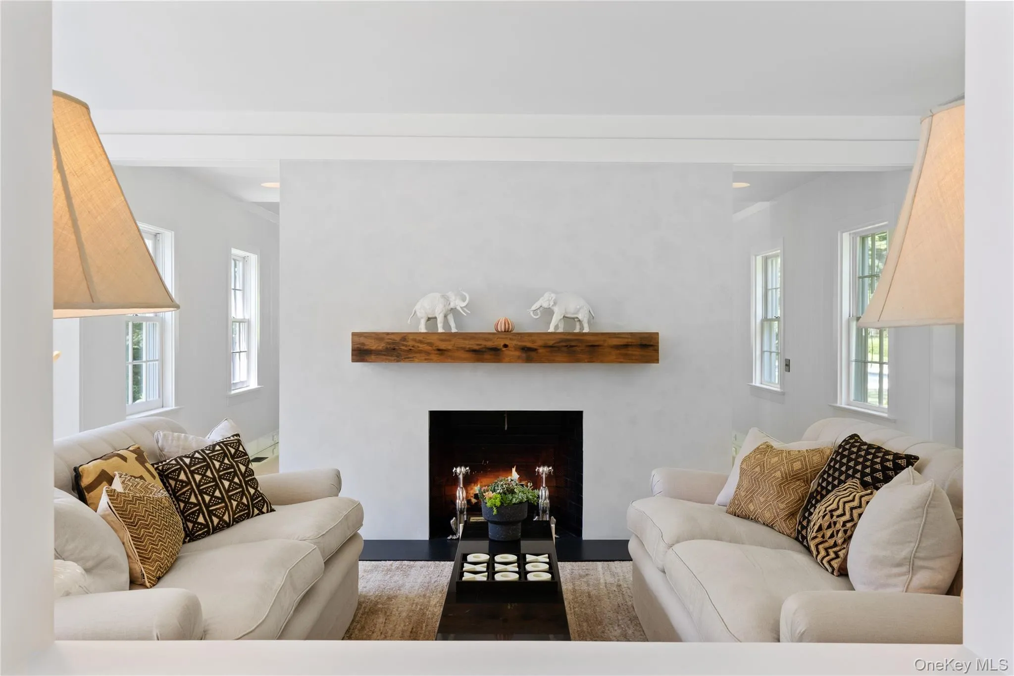Living room with wood finished floors and a fireplace with flush hearth Living room with wood finished floors and a fireplace with flush hearth