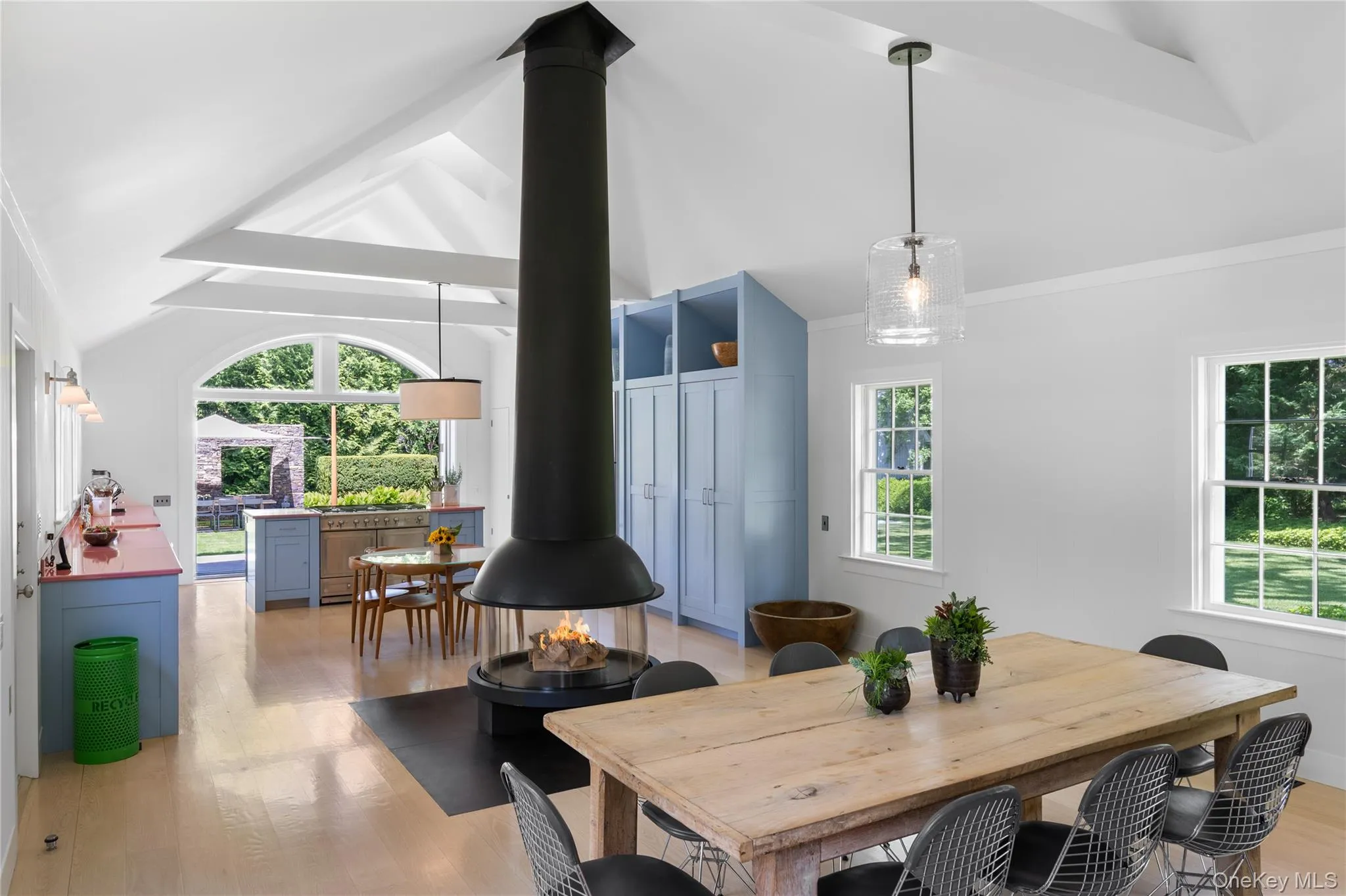 Dining space with a wood stove, light wood finished floors, and crown molding Dining space with a wood stove, light wood finished floors, and crown molding