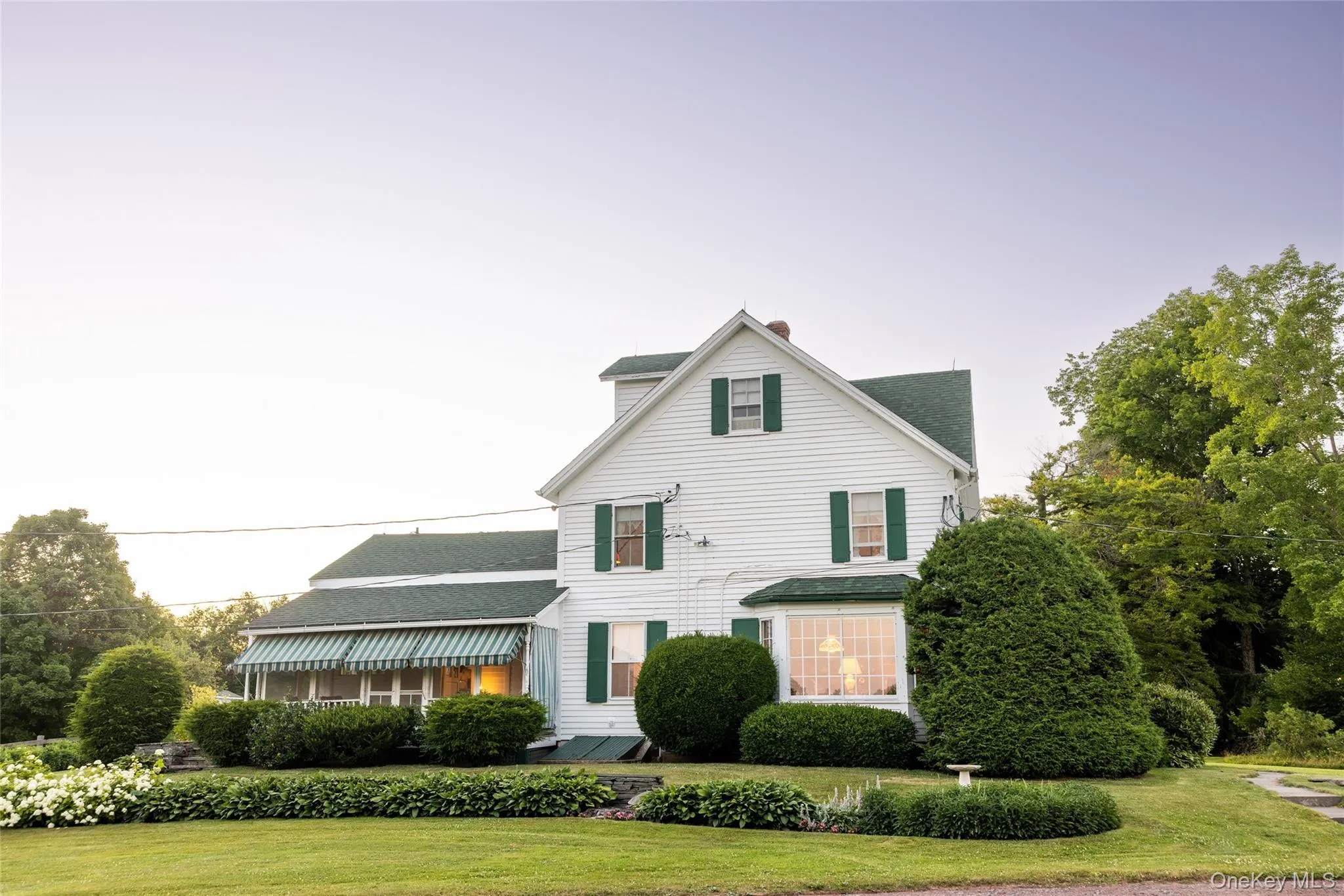 View of front of property featuring a front yard, a chimney, and roof with shingles View of front of property featuring a front yard, a chimney, and roof with shingles