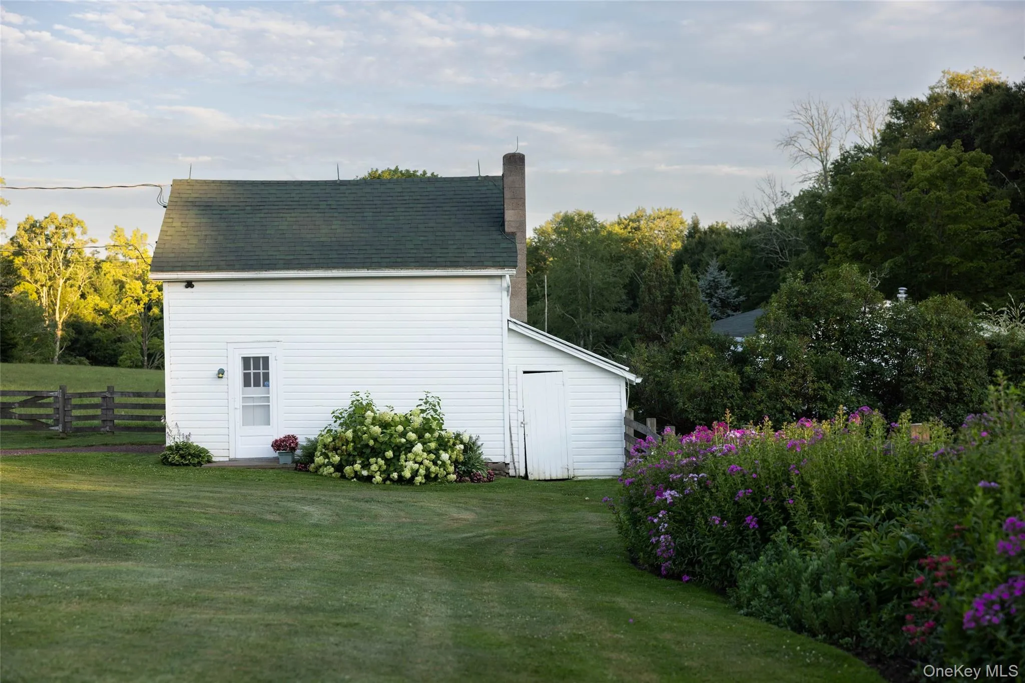 View of side of home featuring a chimney View of side of home featuring a chimney