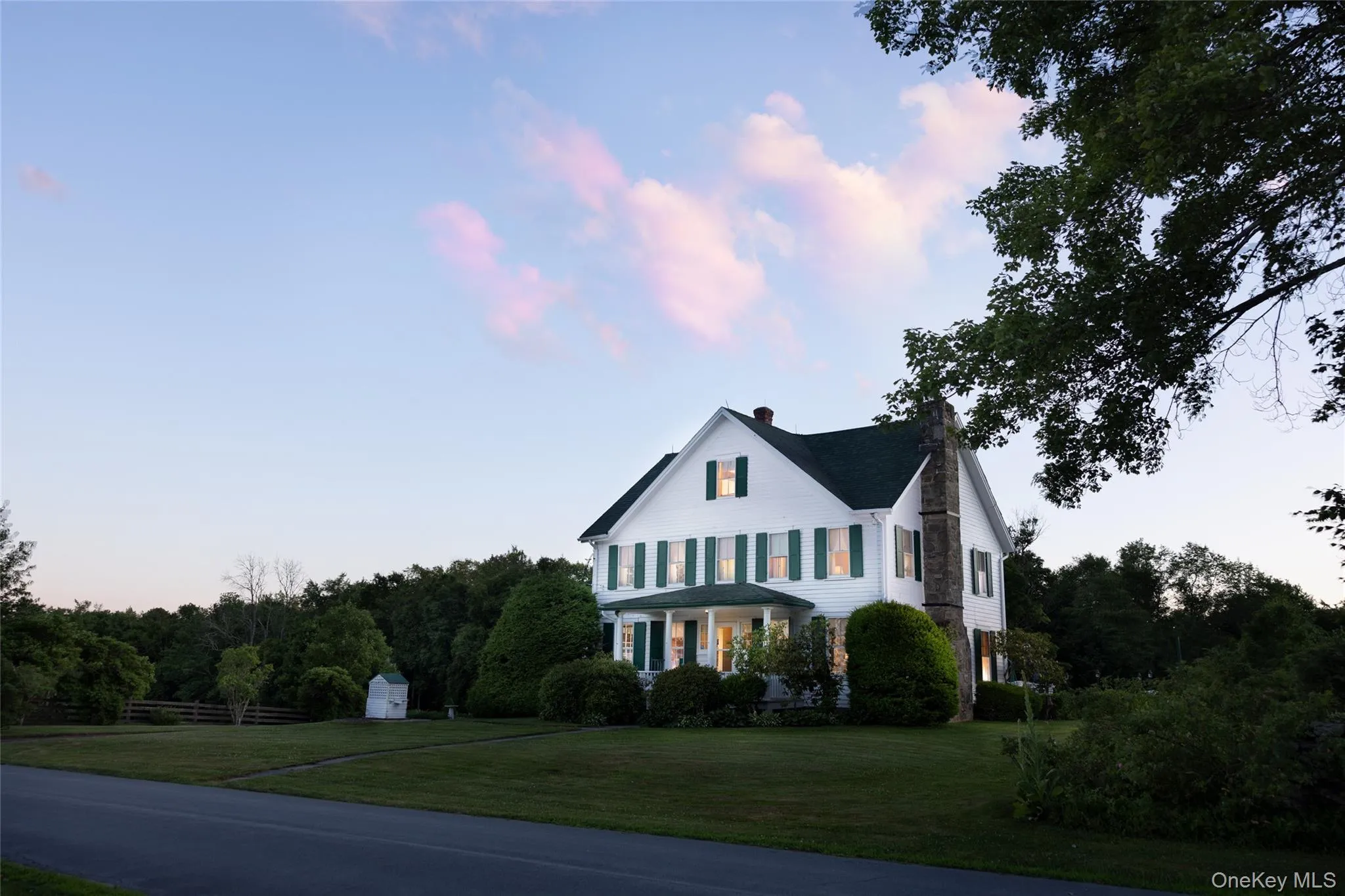 View of front facade with a chimney and a front yard View of front facade with a chimney and a front yard