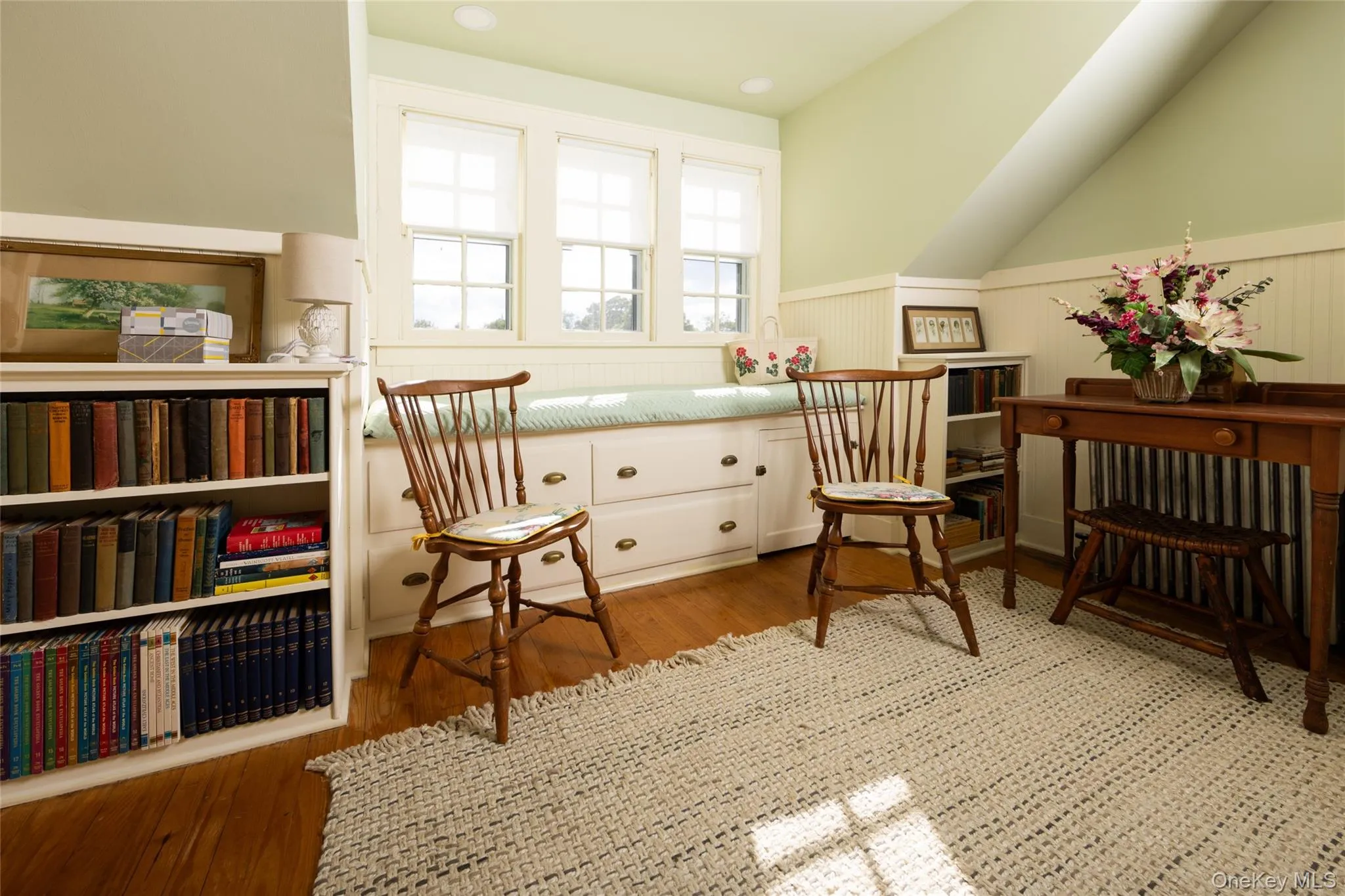 Sitting room featuring a wainscoted wall and wood finished floors Sitting room featuring a wainscoted wall and wood finished floors