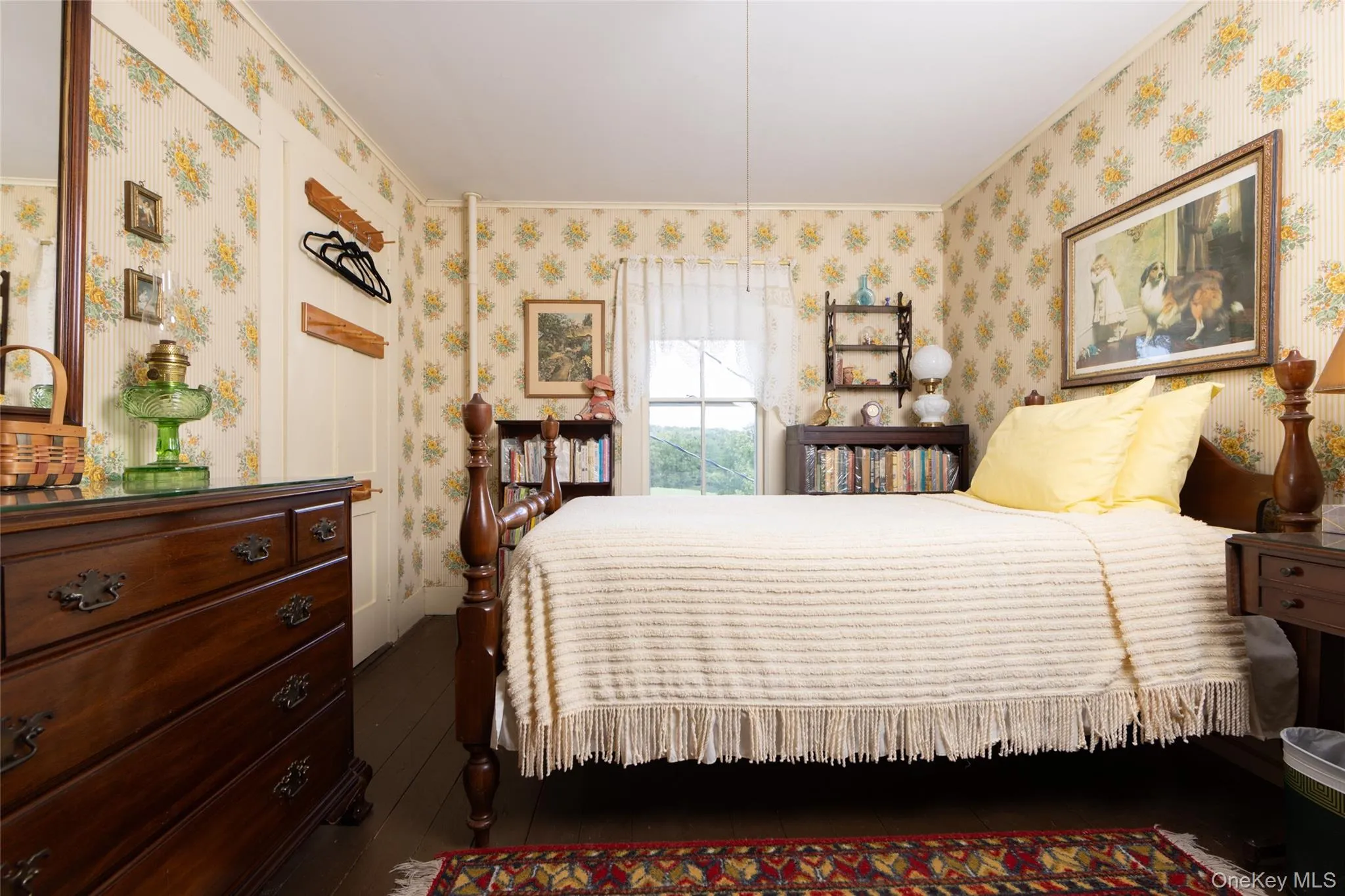 Bedroom with crown molding, wood finished floors, and wallpapered walls Bedroom with crown molding, wood finished floors, and wallpapered walls