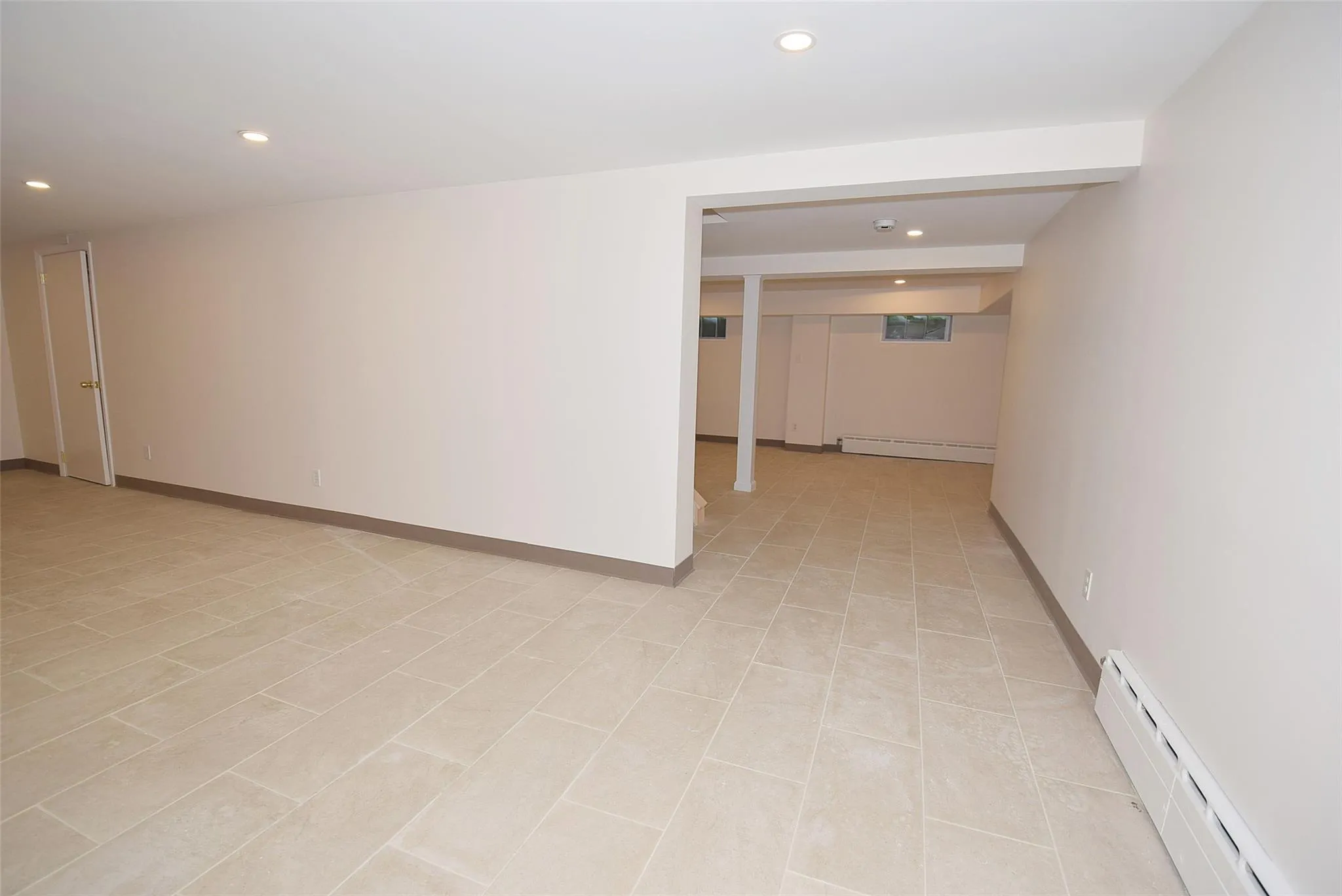 Spare room with baseboard heating, recessed lighting, a baseboard heating unit, and baseboards Spare room with baseboard heating, recessed lighting, a baseboard heating unit, and baseboards