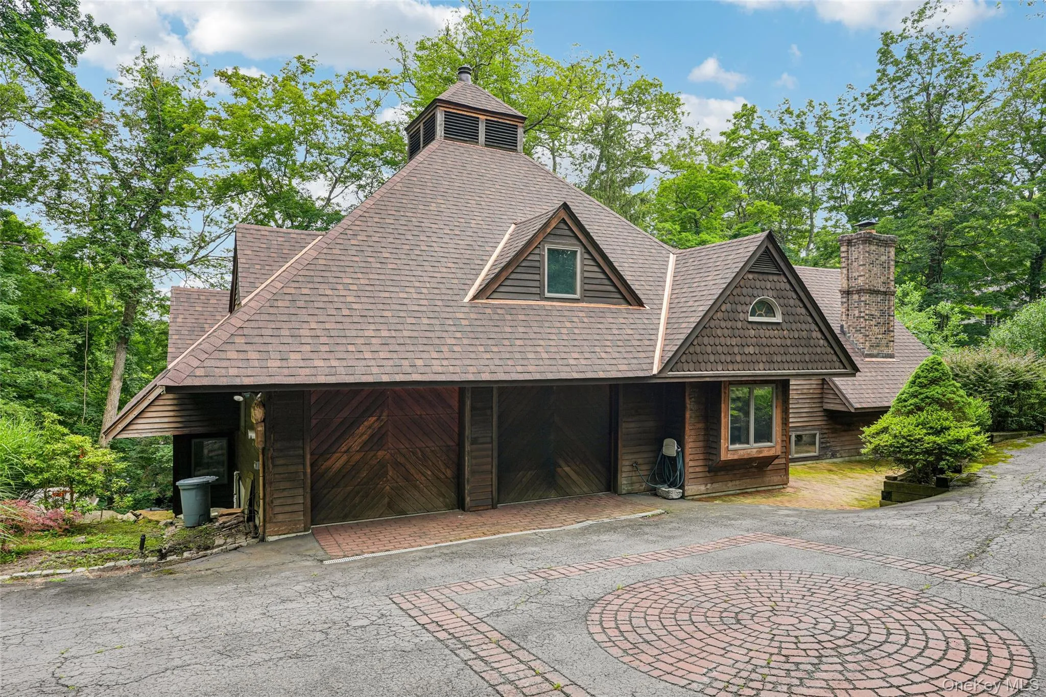 View of front of house with driveway, a shingled brand new roof, a chimney, and an attached garage View of front of house with driveway, a shingled brand new roof, a chimney, and an attached garage