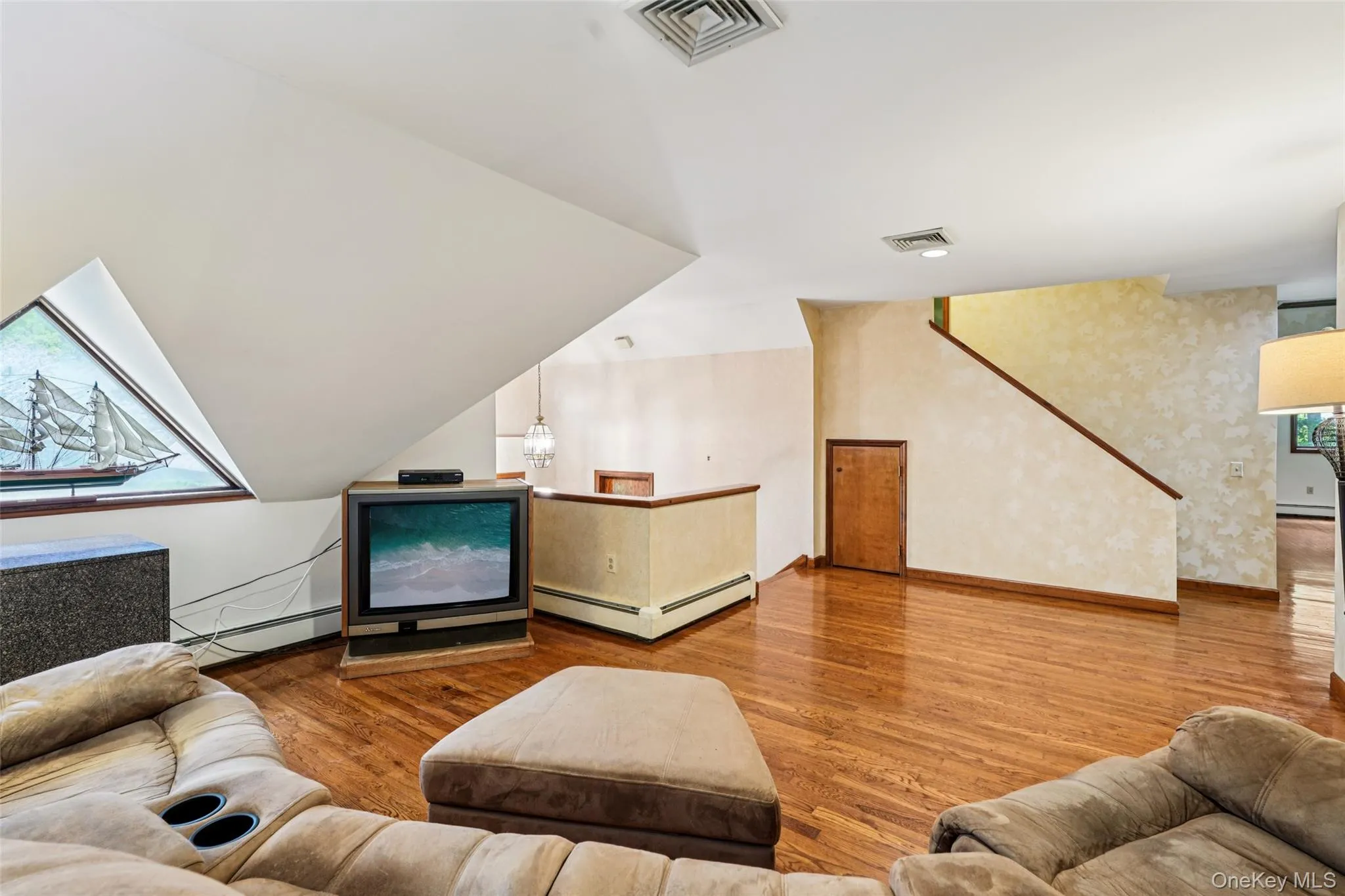 Living room with baseboard heating and wood finished floors Living room with baseboard heating and wood finished floors