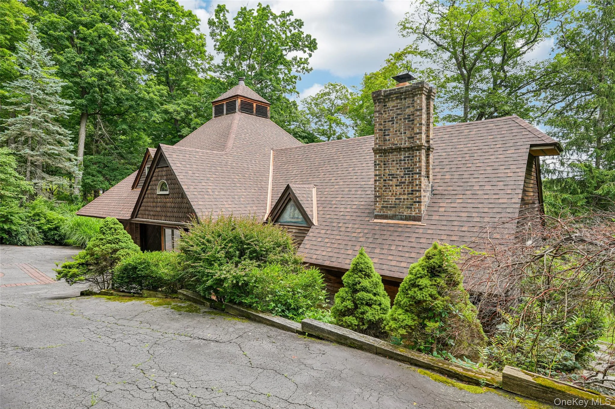 View of side of property featuring a chimney and roof with shingles View of side of property featuring a chimney and roof with shingles