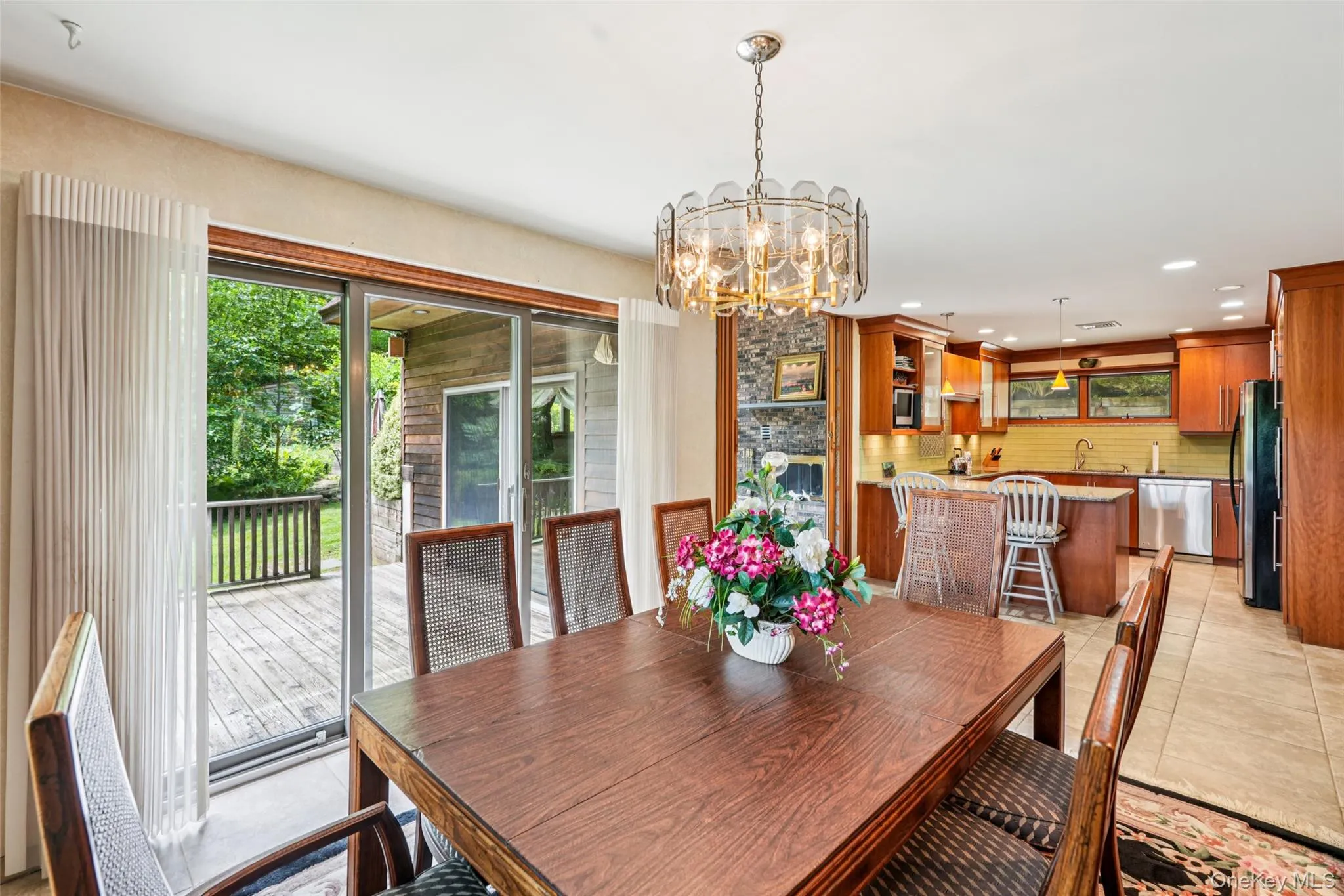 Dining room featuring healthy amount of natural light, a chandelier, light tile patterned floors, and recessed lighting Dining room featuring healthy amount of natural light, a chandelier, light tile patterned floors, and recessed lighting