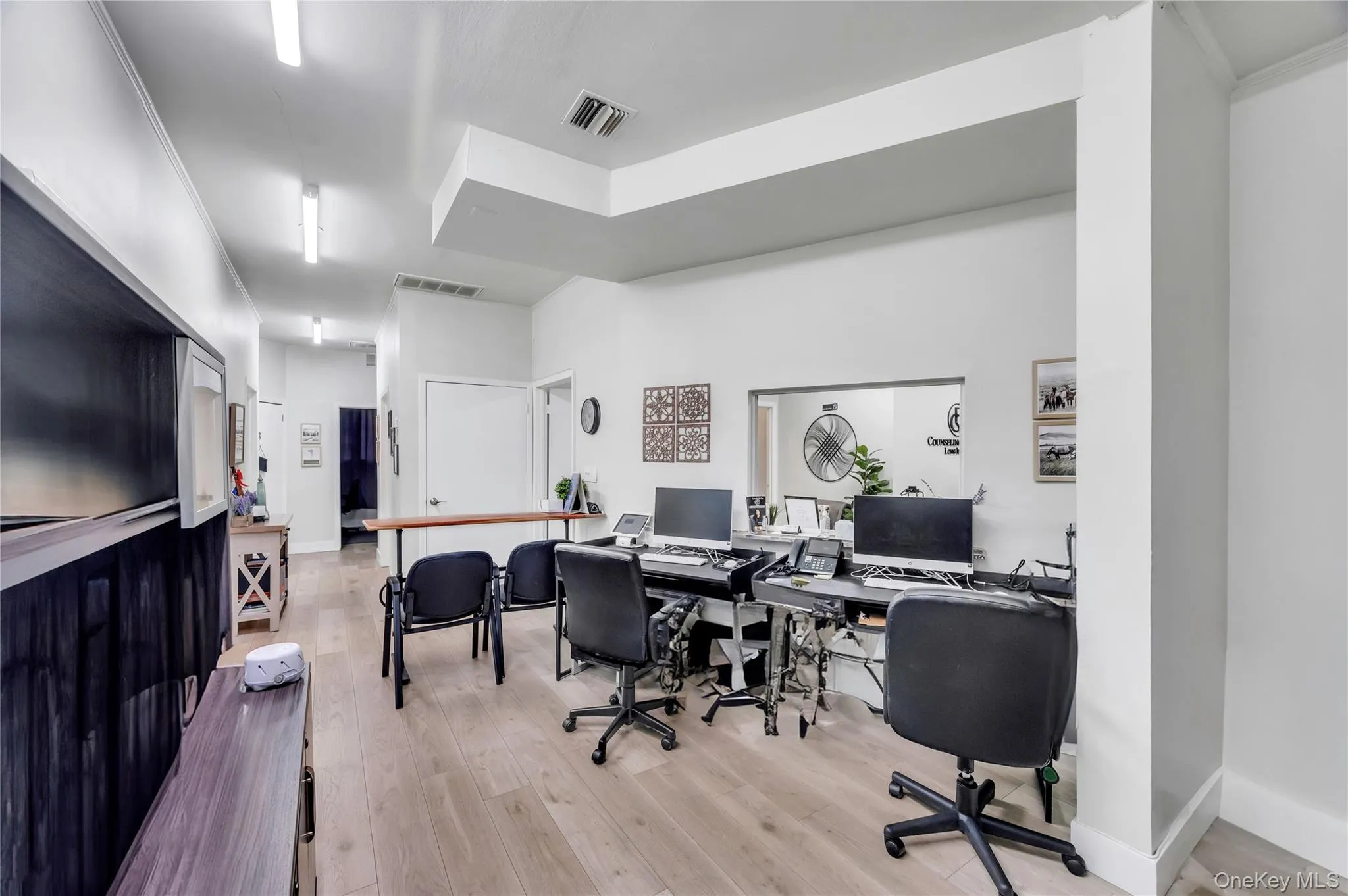 Office with wood finished floors, baseboards, and ornamental molding Office with wood finished floors, baseboards, and ornamental molding