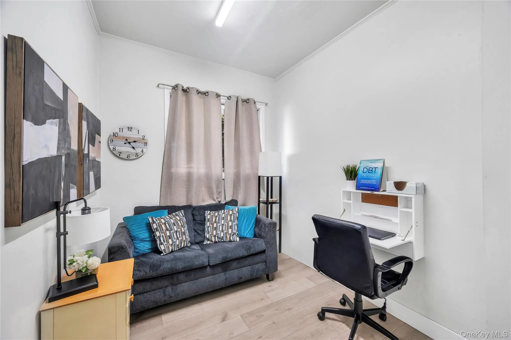Home office featuring ornamental molding and light wood-style flooring Home office featuring ornamental molding and light wood-style flooring