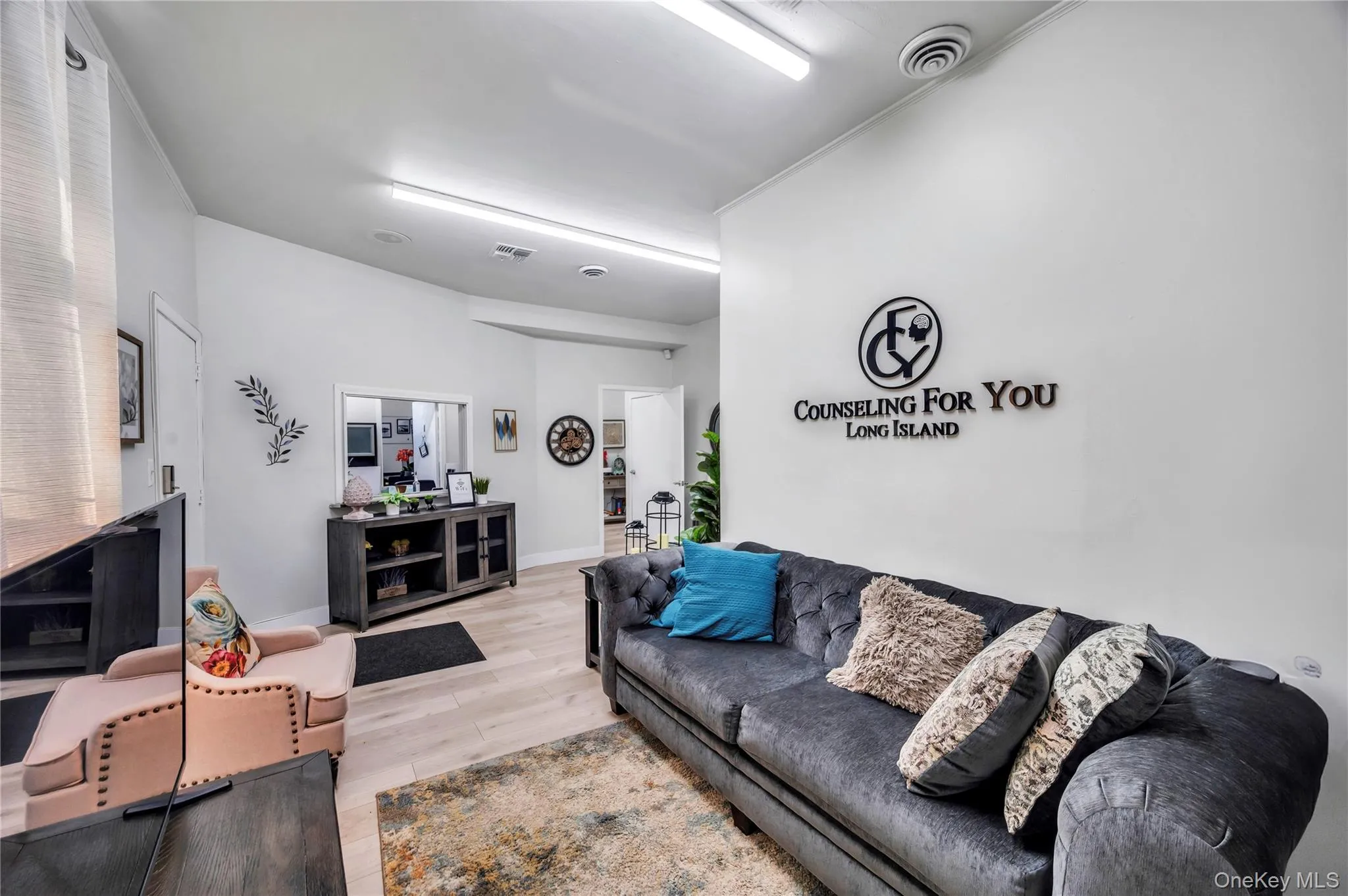 Living area featuring wood finished floors and baseboards Living area featuring wood finished floors and baseboards