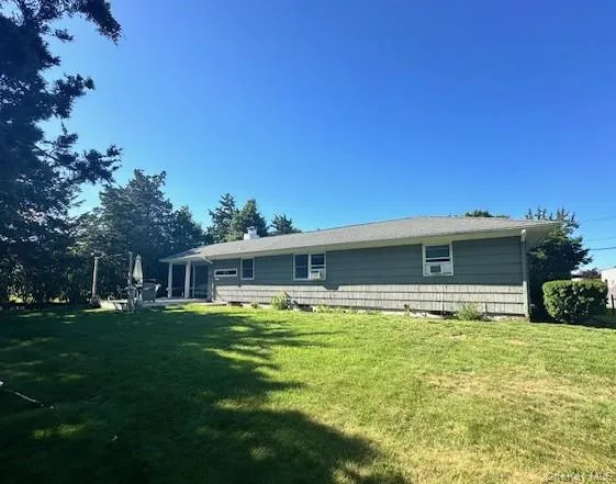Back of house featuring a yard Back of house featuring a yard