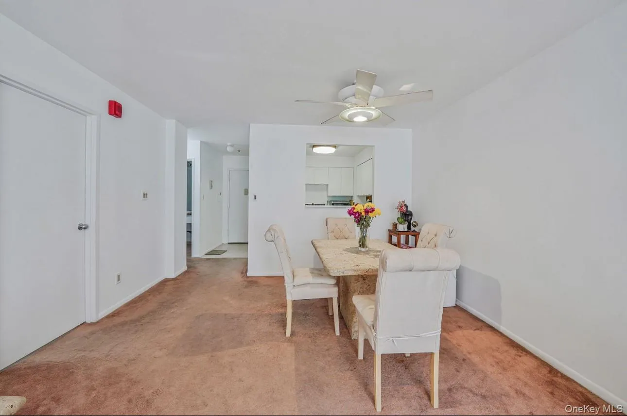 Dining area with light colored carpet and ceiling fan Dining area with light colored carpet and ceiling fan