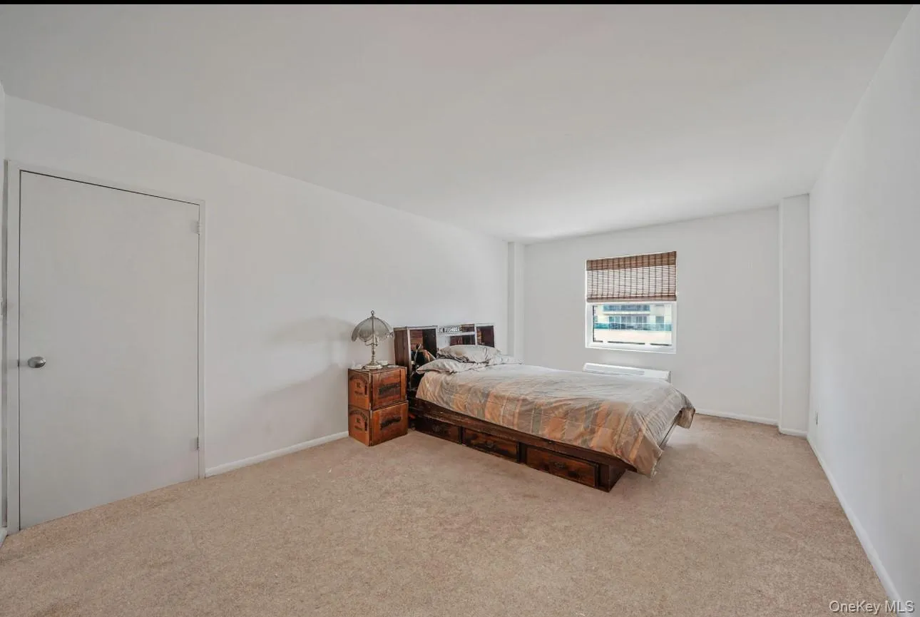 Bedroom featuring carpet flooring and baseboards Bedroom featuring carpet flooring and baseboards