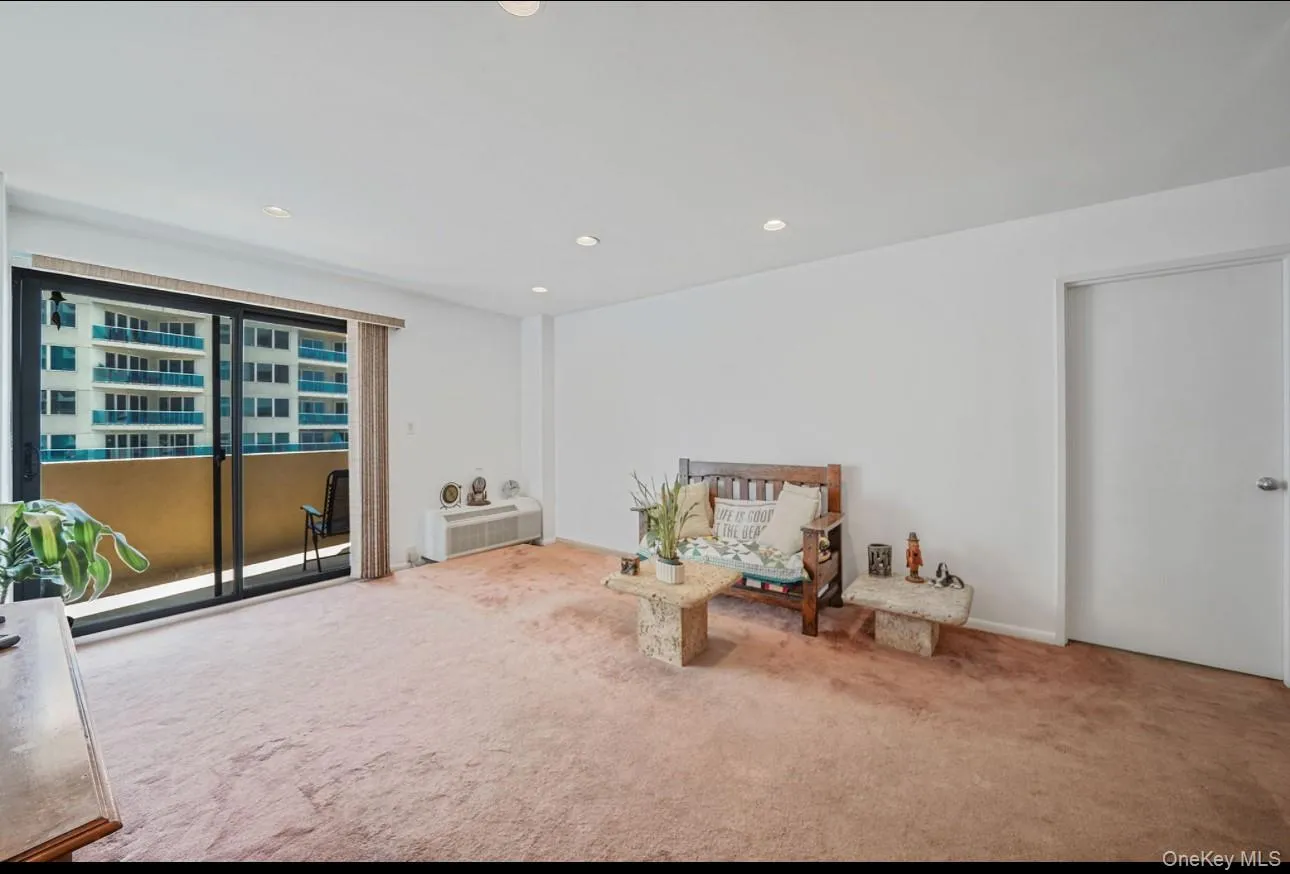 Living area featuring carpet floors and recessed lighting Living area featuring carpet floors and recessed lighting