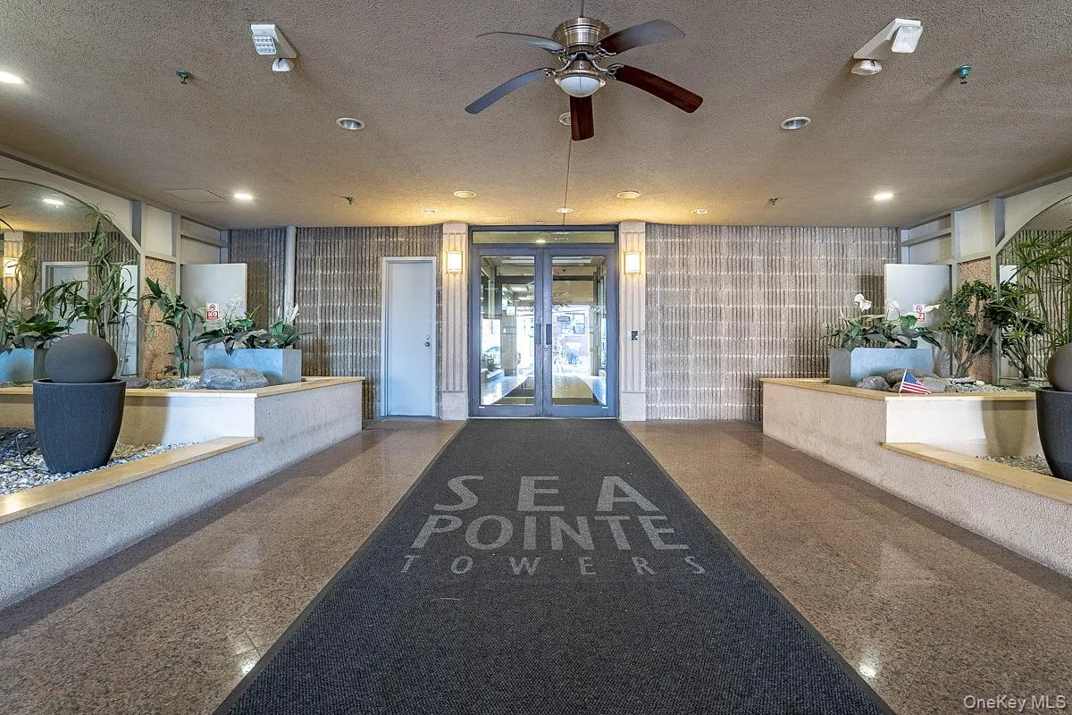 Reception featuring wallpapered walls, a textured ceiling, ceiling fan, recessed lighting, and french doors Reception featuring wallpapered walls, a textured ceiling, ceiling fan, recessed lighting, and french doors