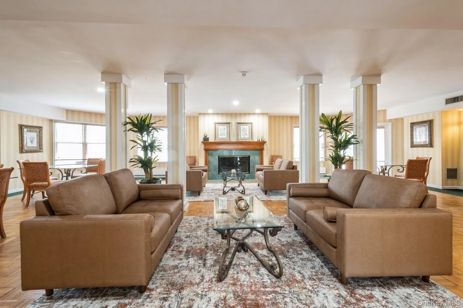 Community room with decorative columns and a premium fireplace Community room with decorative columns and a premium fireplace