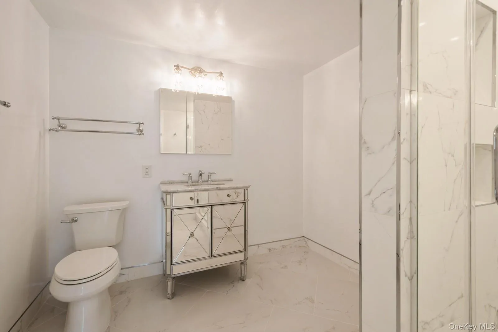 Bathroom with tiles, vanity, and a marble finish shower Bathroom with tiles, vanity, and a marble finish shower