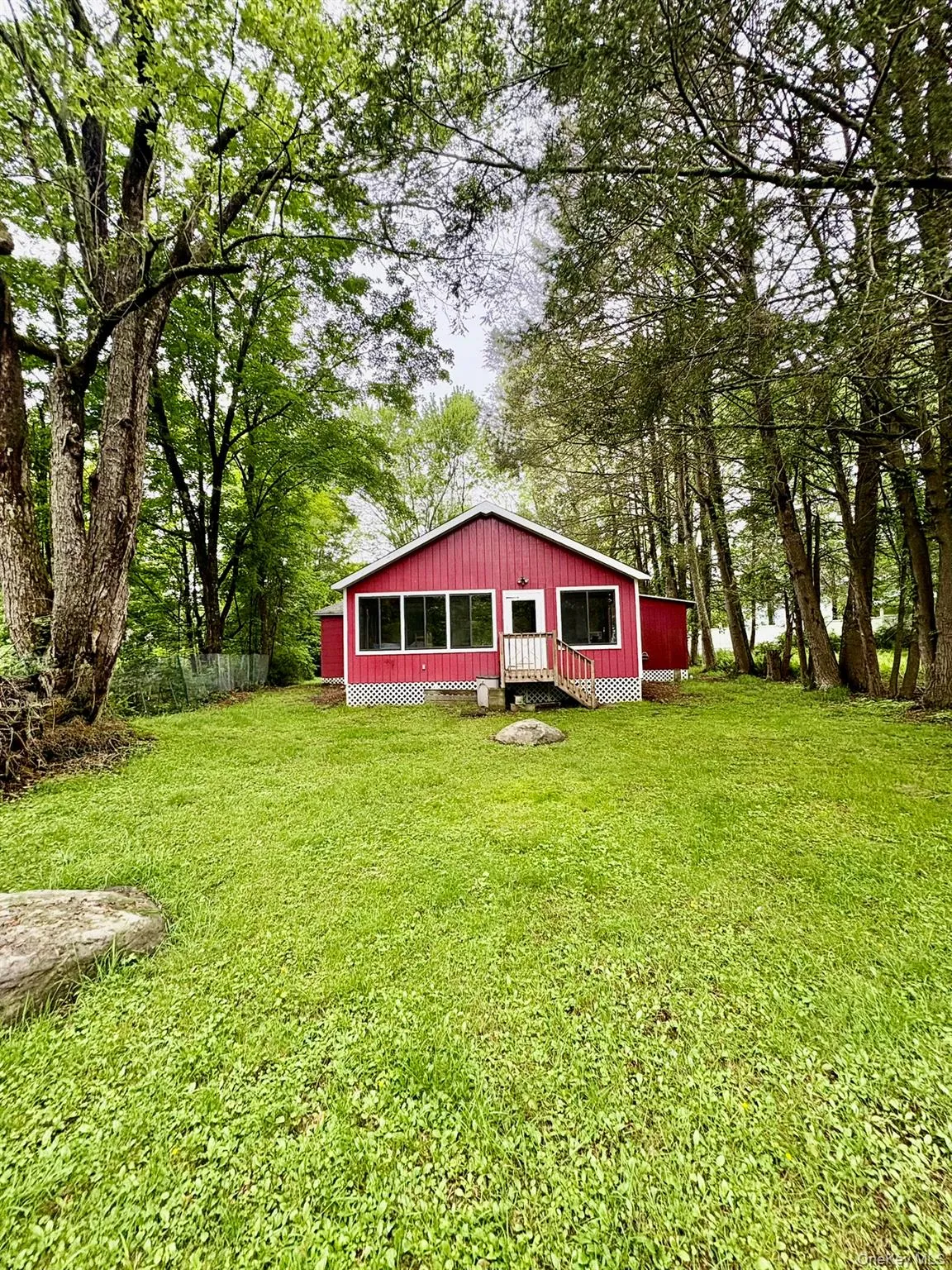 Back of property featuring a yard Back of property featuring a yard