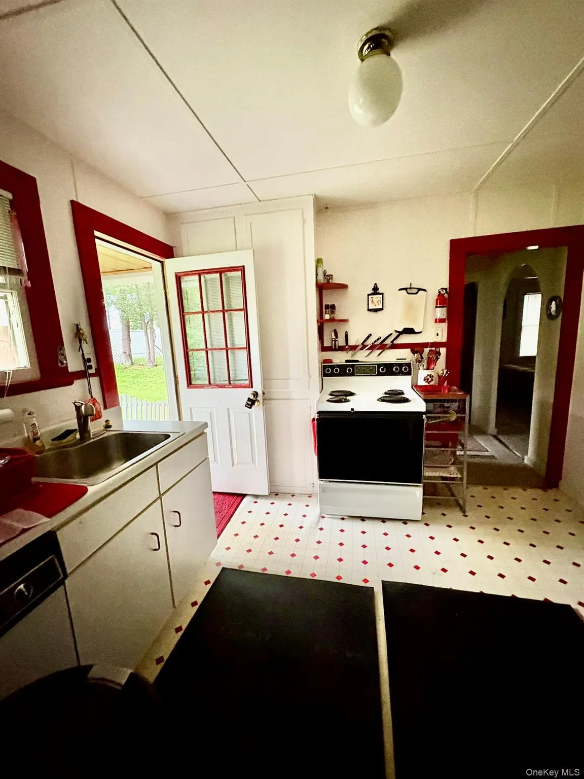Kitchen featuring electric range oven and a sink Kitchen featuring electric range oven and a sink