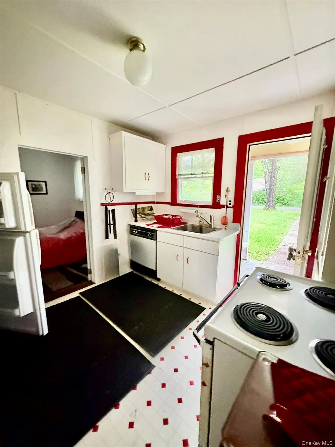 Kitchen with white appliances, a sink, white cabinetry, and light countertops Kitchen with white appliances, a sink, white cabinetry, and light countertops