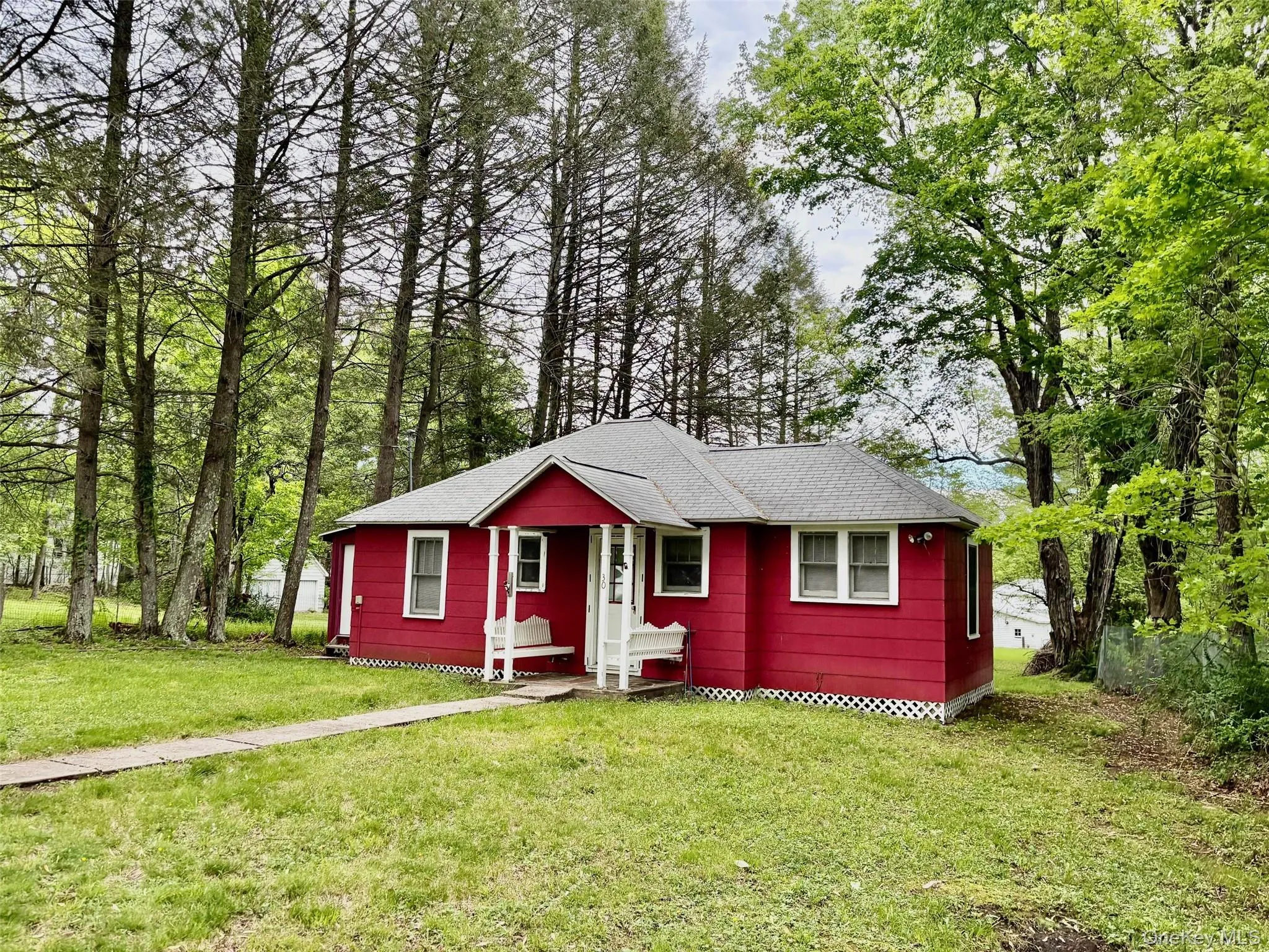 View of front of property with roof with shingles and a front lawn View of front of property with roof with shingles and a front lawn
