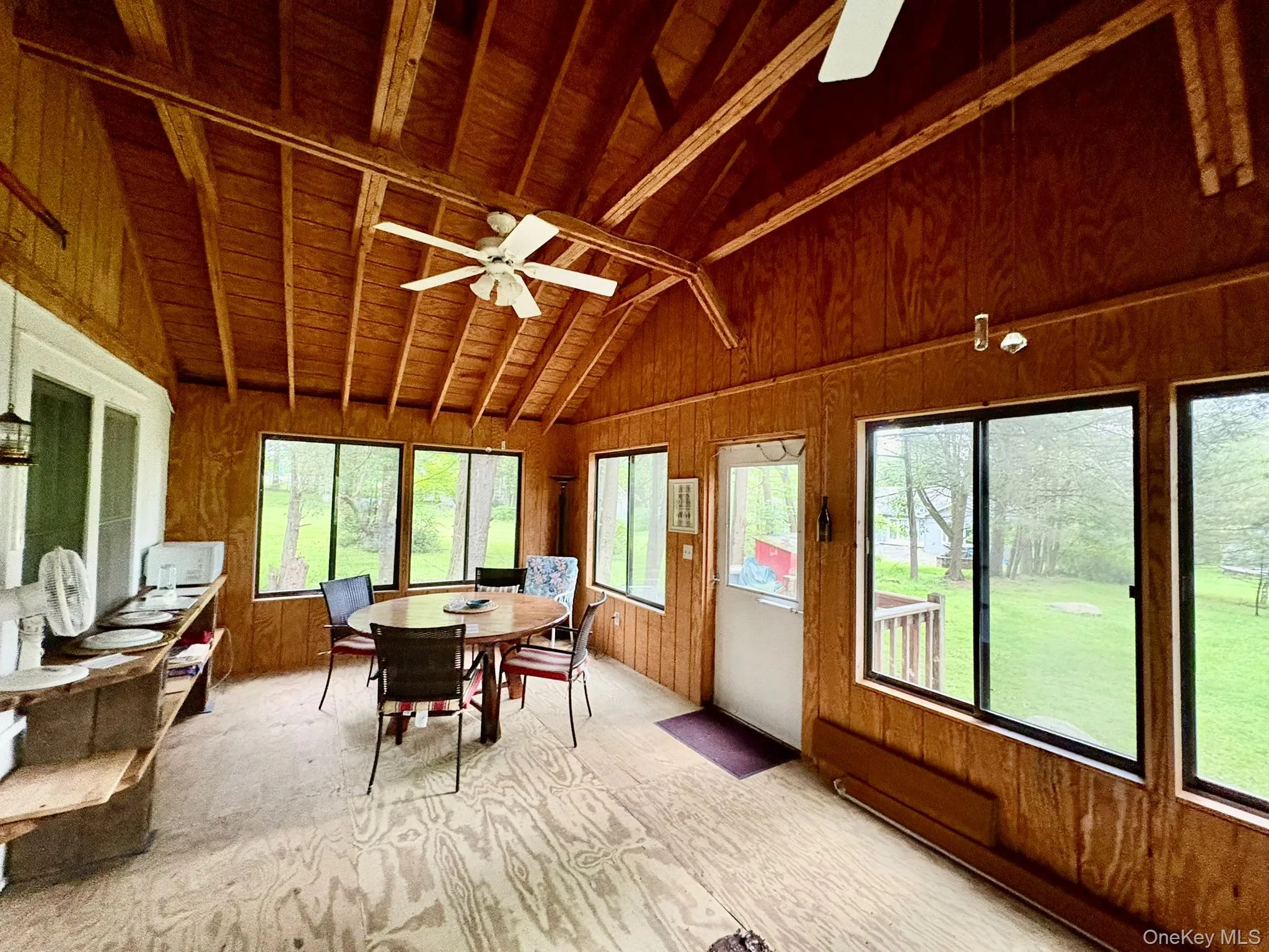 Sunroom / solarium featuring wooden walls and wooden ceiling Sunroom / solarium featuring wooden walls and wooden ceiling