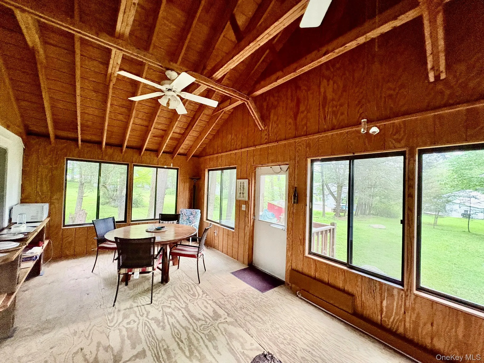 Sunroom / solarium featuring wooden walls and wooden ceiling Sunroom / solarium featuring wooden walls and wooden ceiling