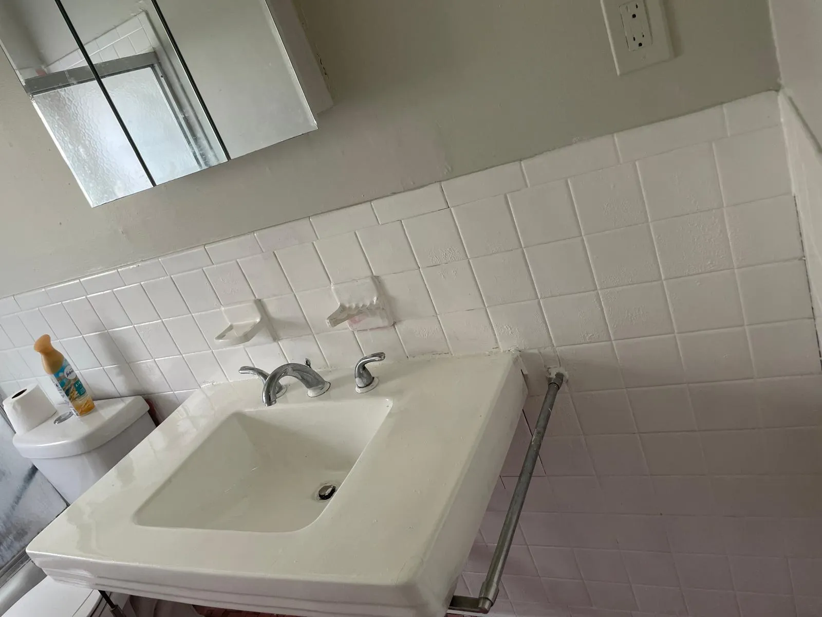 Bathroom featuring tile walls and wainscoting Bathroom featuring tile walls and wainscoting