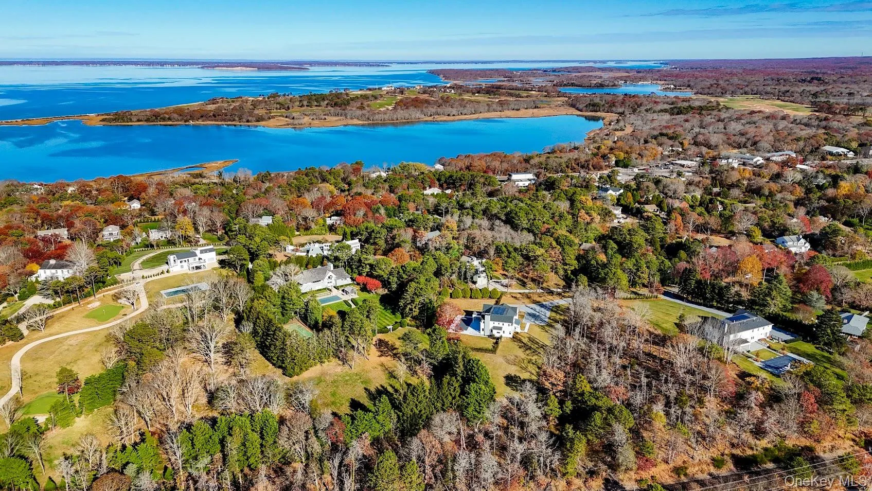 Aerial view of property and surrounding area with a nearby body of water Aerial view of property and surrounding area with a nearby body of water