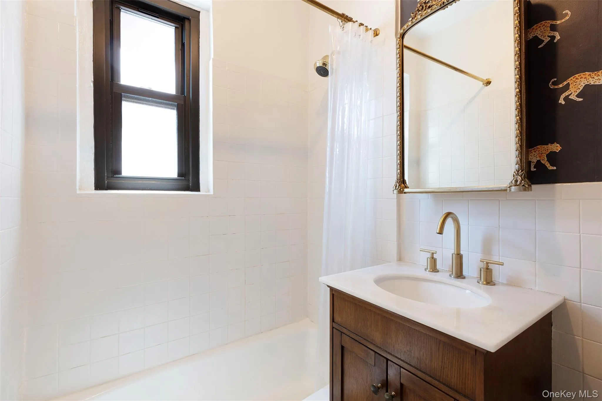 Full bath with vanity, shower / bath combination with curtain, and backsplash Full bath with vanity, shower / bath combination with curtain, and backsplash