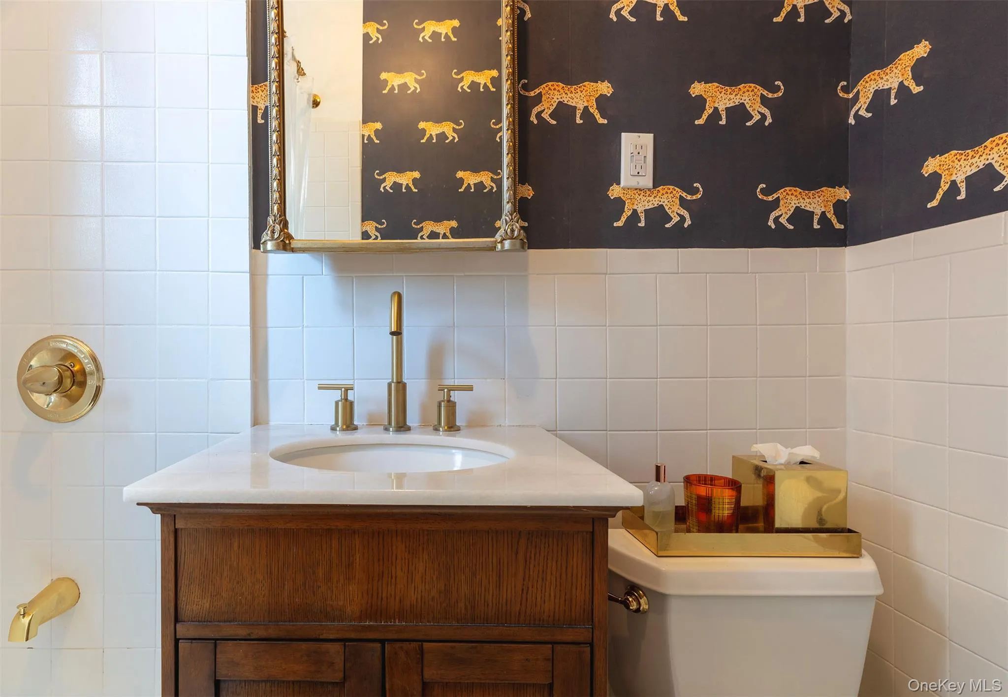 Bathroom with vanity, tile walls, toilet, and backsplash Bathroom with vanity, tile walls, toilet, and backsplash