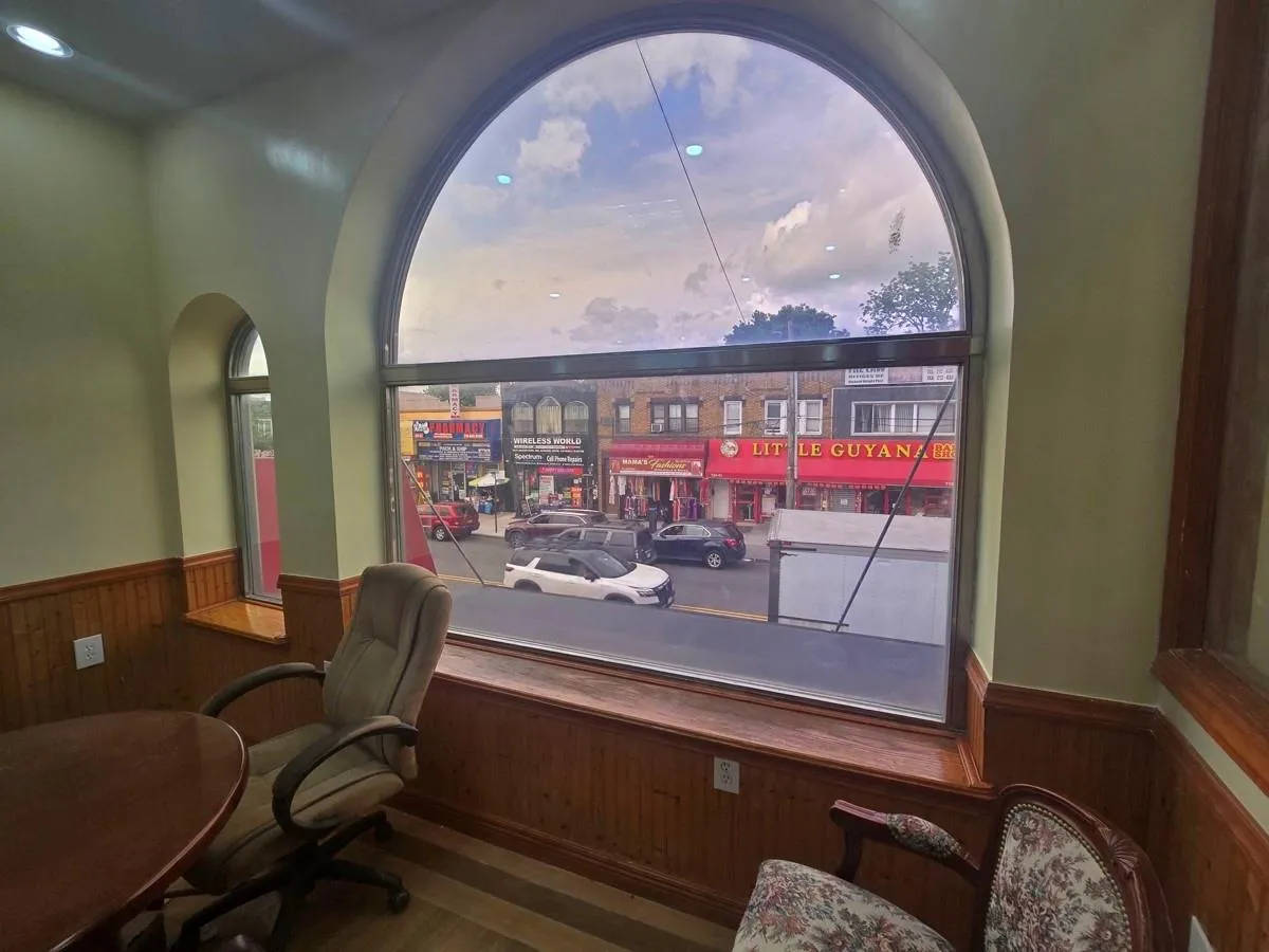 Office area with wood walls, a wainscoted wall, wood finished floors, and arched walkways Office area with wood walls, a wainscoted wall, wood finished floors, and arched walkways
